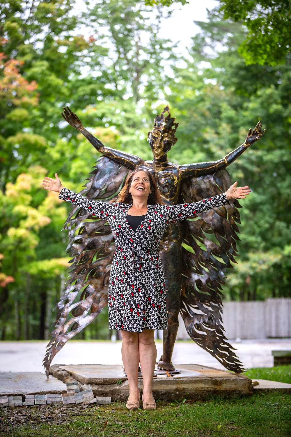 a person posing in front of a statue
