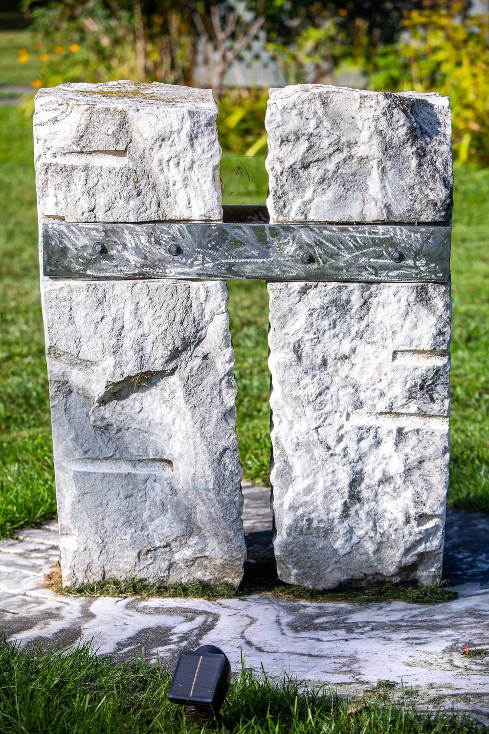 a stone bench in a park