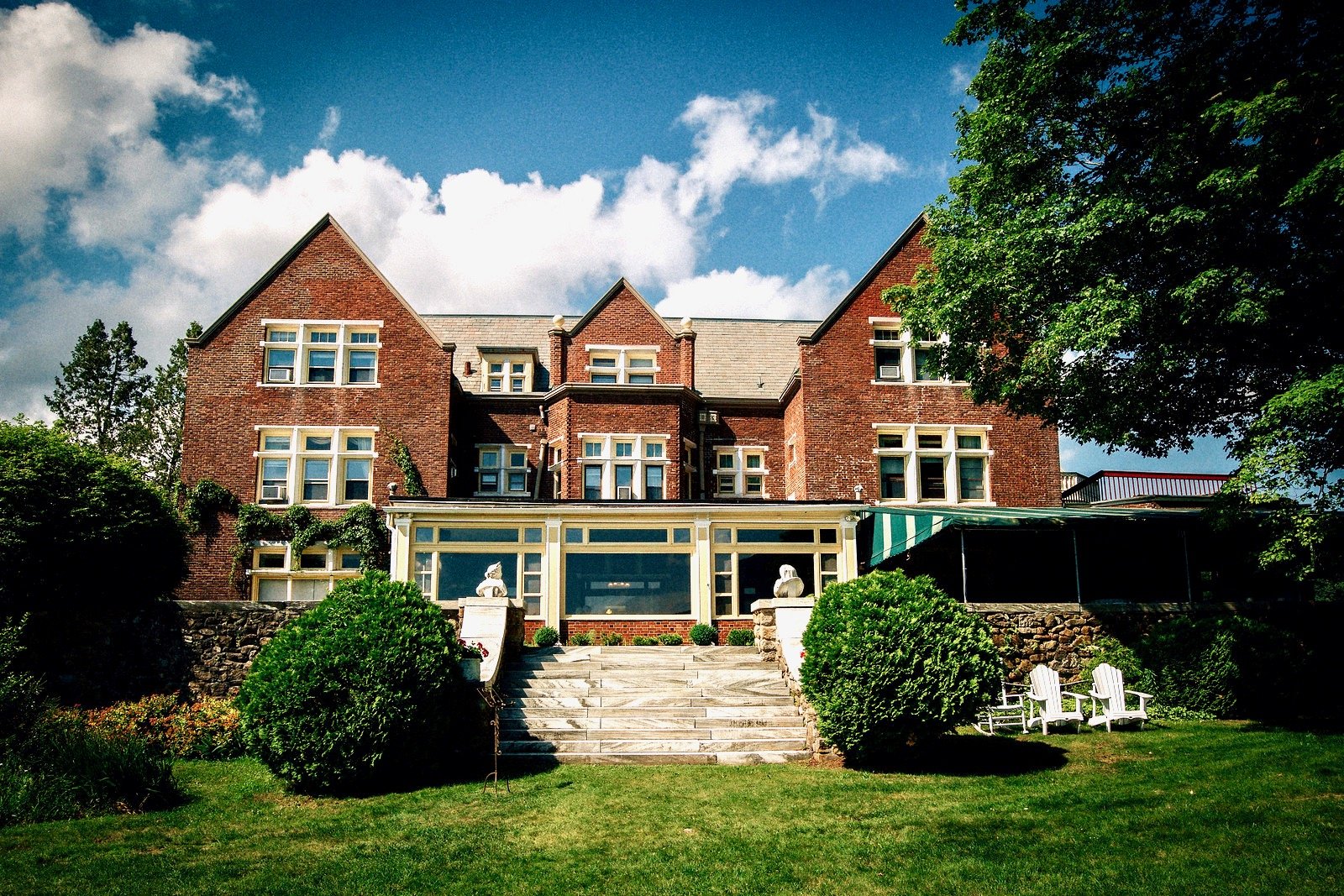 Wilburton Mansion Blue Sky Emerald Trees.jpeg