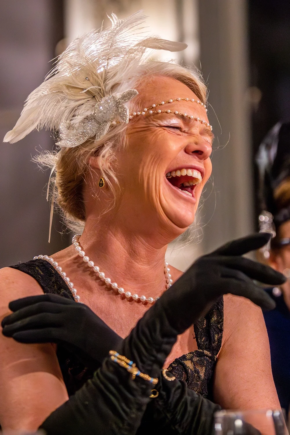 a woman with a white wig and black gloves