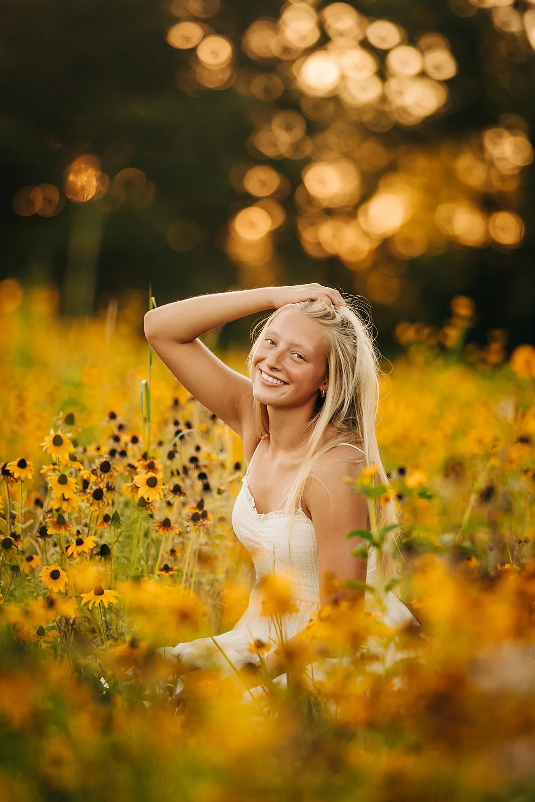 Senior portrait of Kherinton surrounded by yellow wildflowers during golden hour in the Lehigh Valley