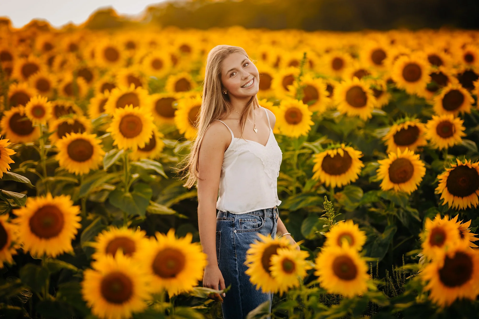 Amelia's senior portrait in a sunflower field during a summer session in the Lehigh Valley.