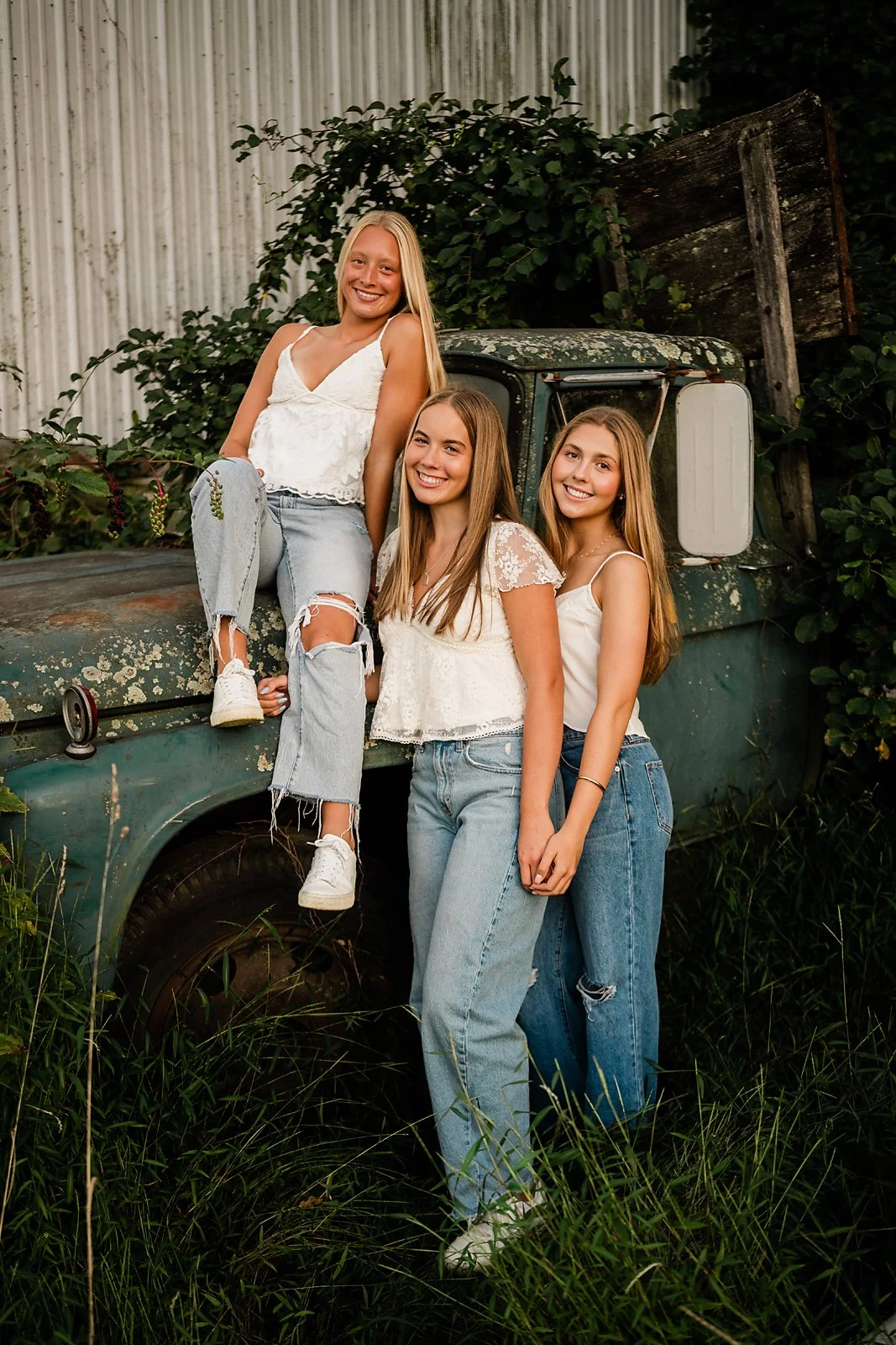 Senior portrait sitting on a vintage truck during a Lehigh Valley senior photography session.