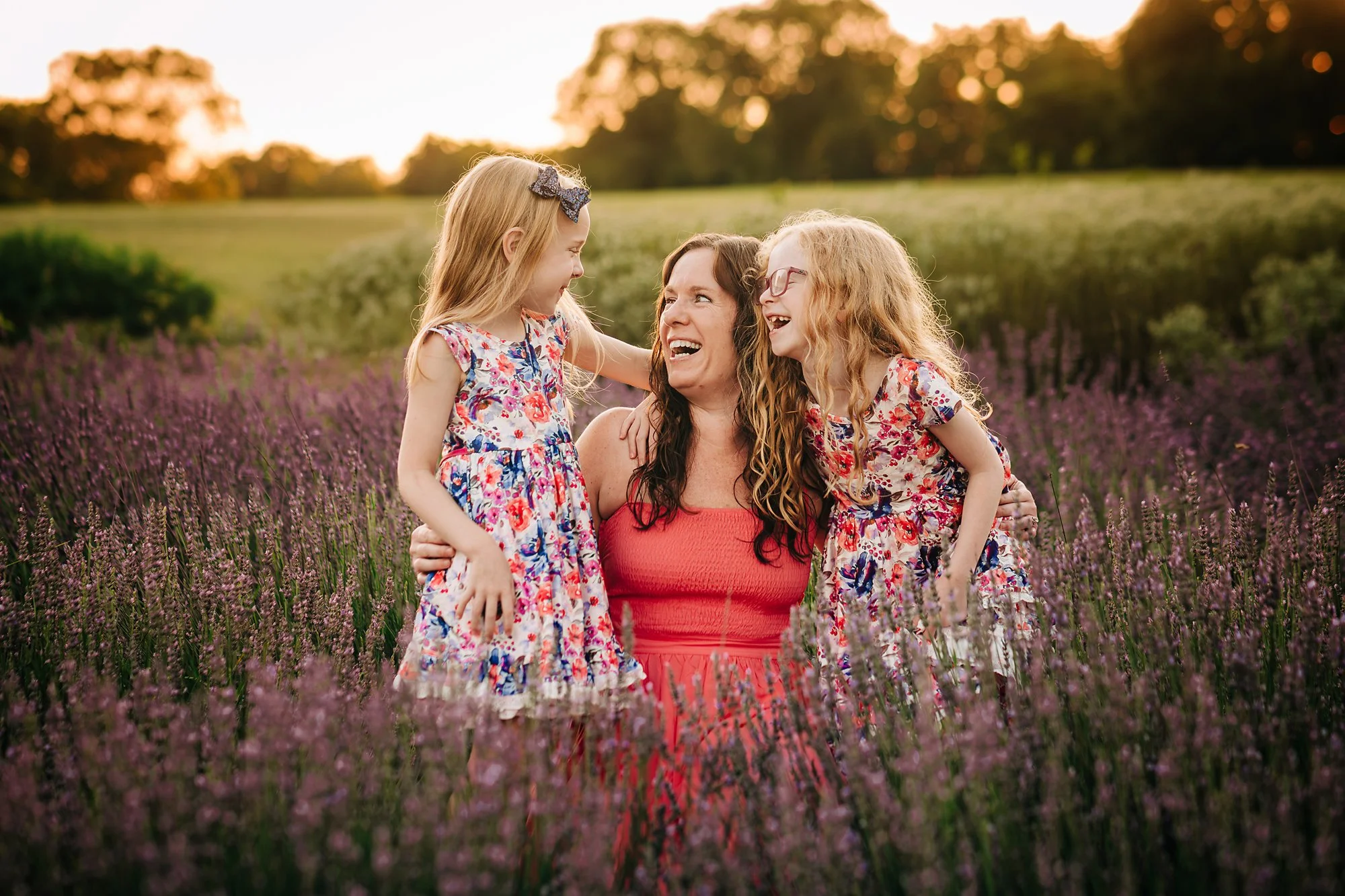 Genuine laughter between a mom and her daughters during a relaxed Lehigh Valley family photo session.