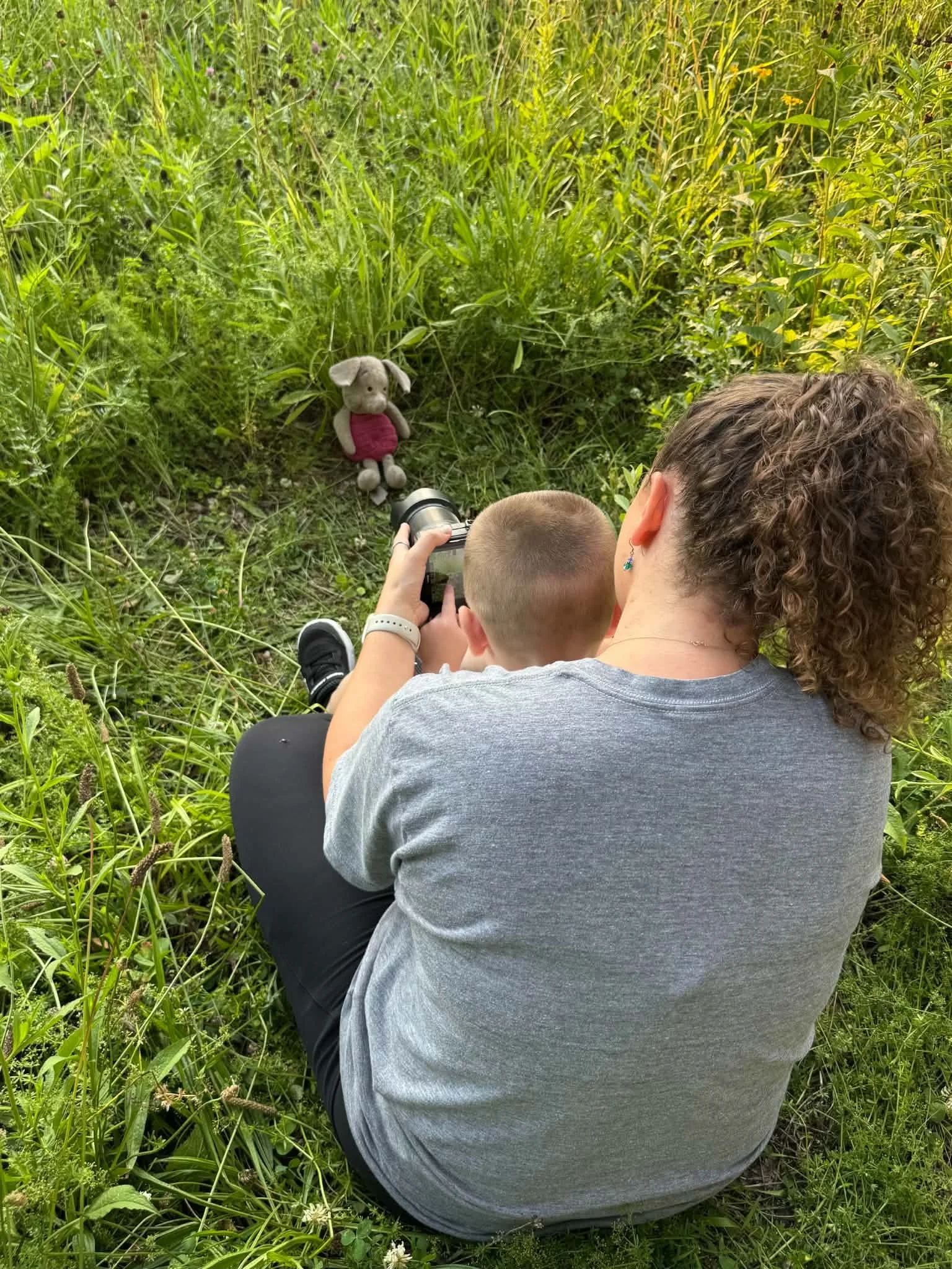 Photographer helping a young child feel comfortable during a relaxed family photography session in Lehigh Valley.