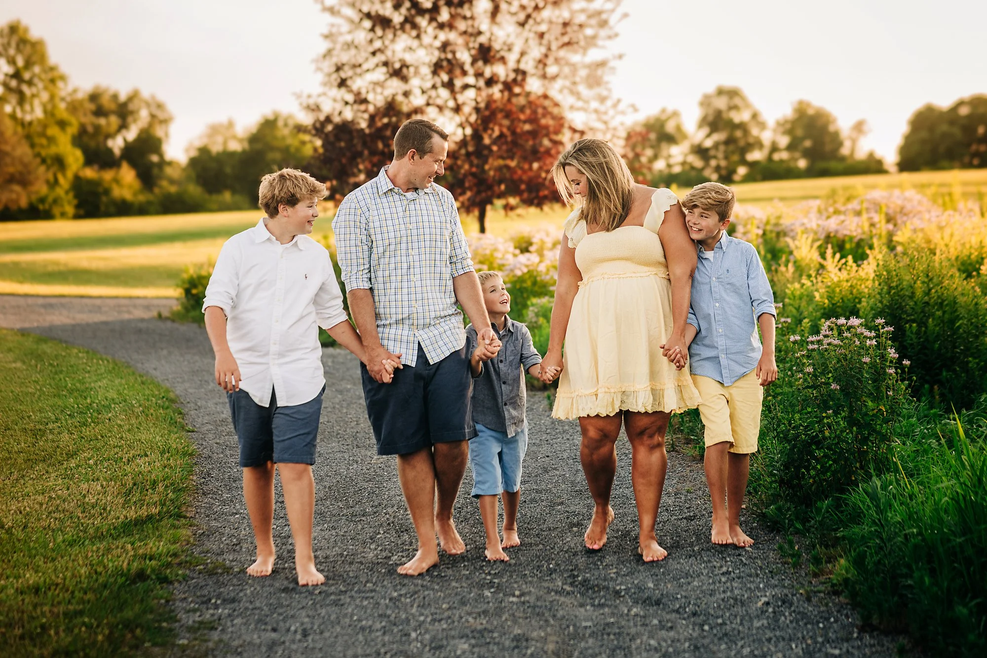 Family walking together during a relaxed outdoor family photography session in the Lehigh Valley at sunset.
