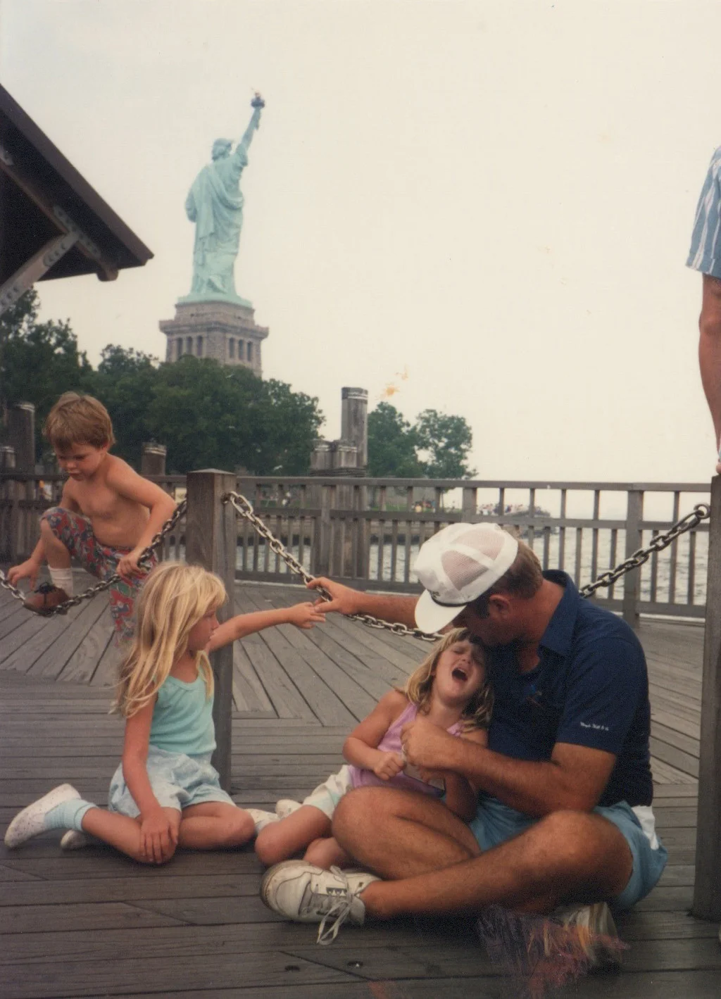 Liberty Island, waiting for the ferry with my father and fussy sister . August 6, 1989