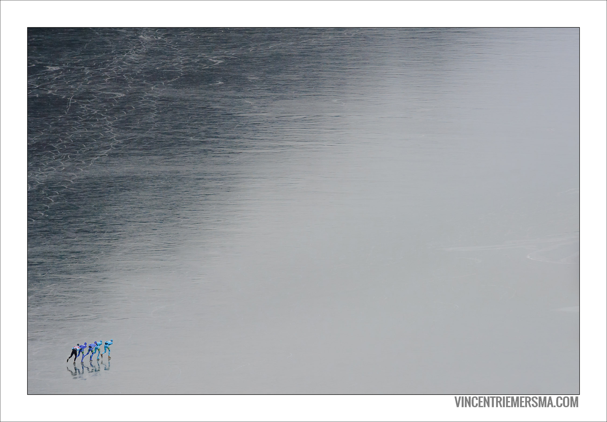 Iceskaters on the pitchblack ice of the big lake of Weissensee