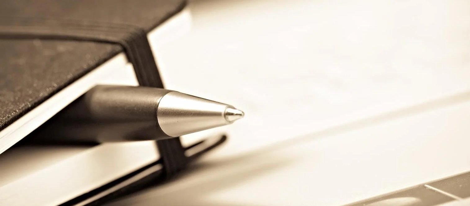 bigstock-notepad-with-pen-12940955.jpg
