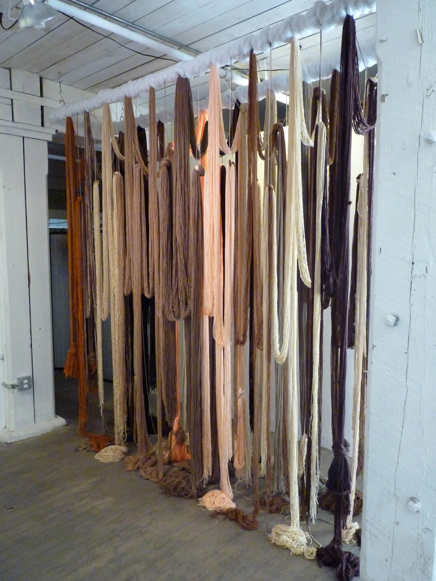 A Valence, 2012, Yarn, wood, poly-fil and hardware, 10 x 2 x 10 feet