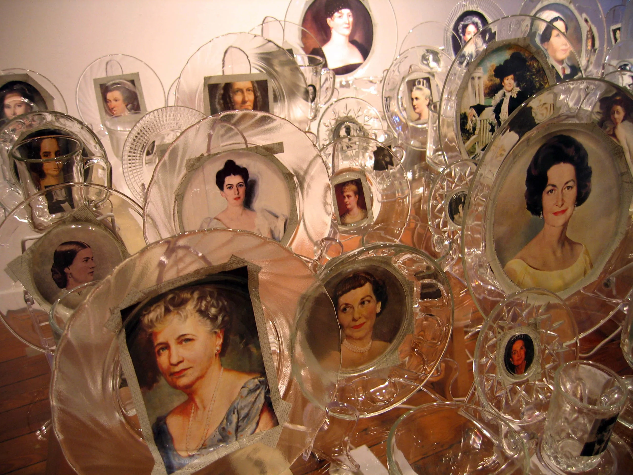 First Love (detail), 2007, Glass, paper, tape, plexiglass, wood and fluorescent lights 41 cups with president, 41 saucers with first lady, 4 x 3 x 3'