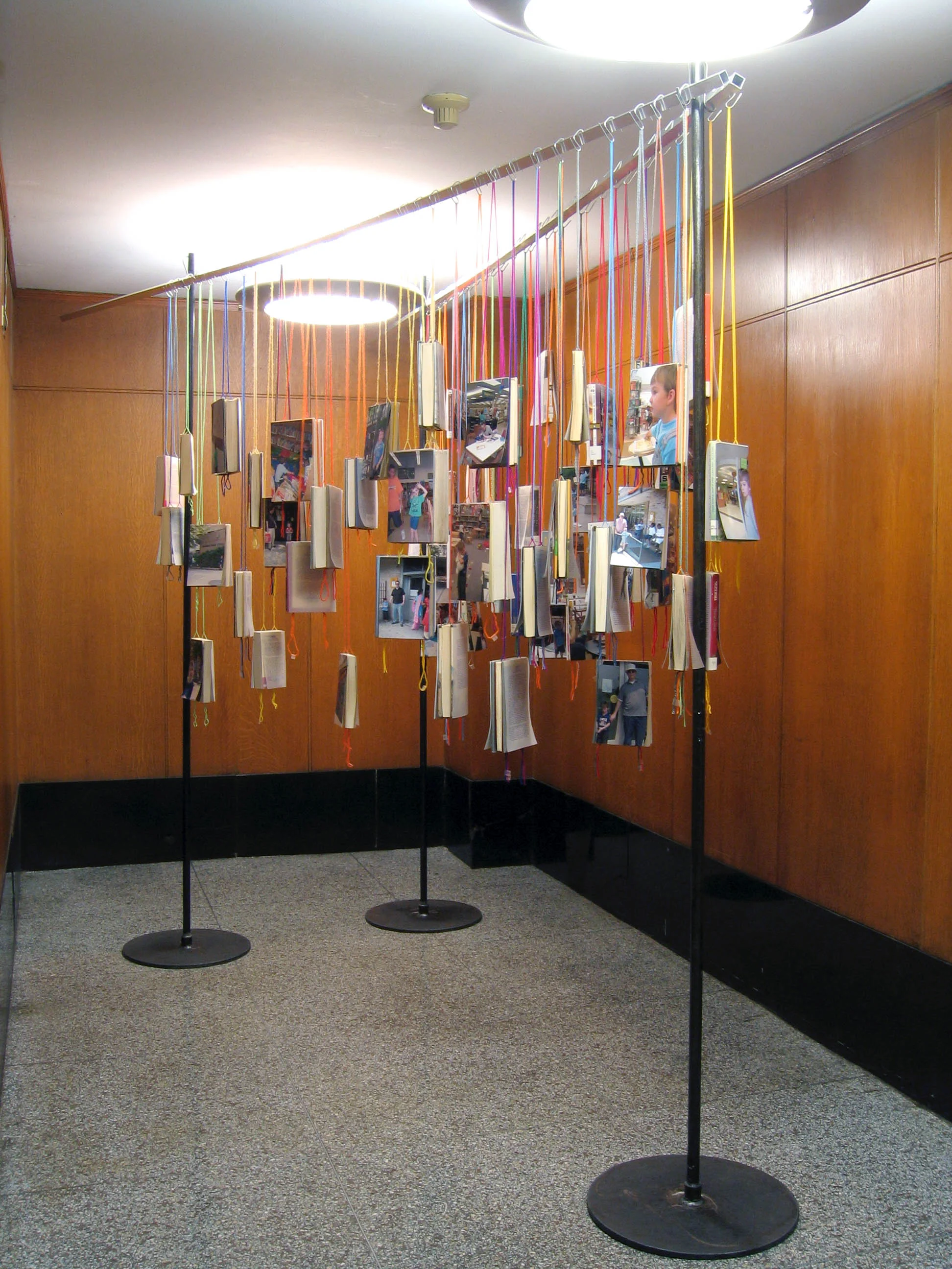 bioGRAPHY: A Site Specific Project for the Brooklyn Public Library, 2005, 60 library books, paper, photo, yarn, tape and metal, 7 x 4 x 11' (Installation view)