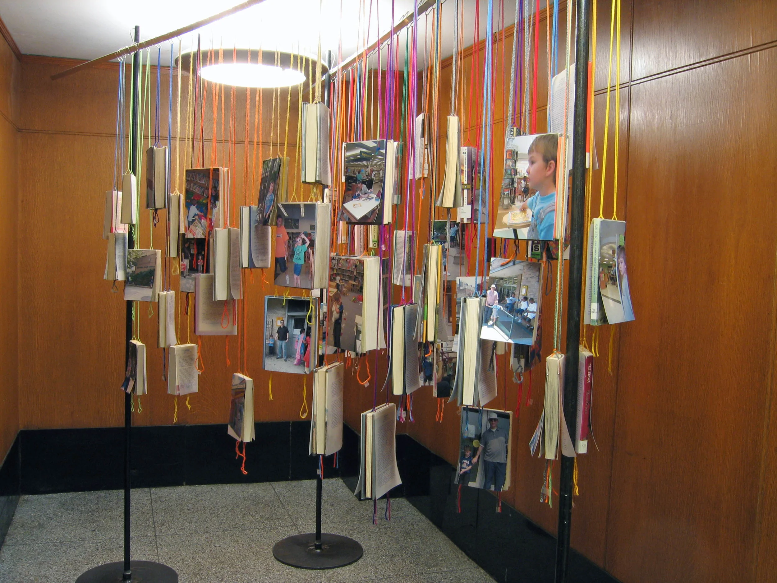 bioGRAPHY: A Site Specific Project for the Brooklyn Public Library, 2005, 60 library books, paper, photo, yarn, tape and metal, 7 x 4 x 11' (Installation)
