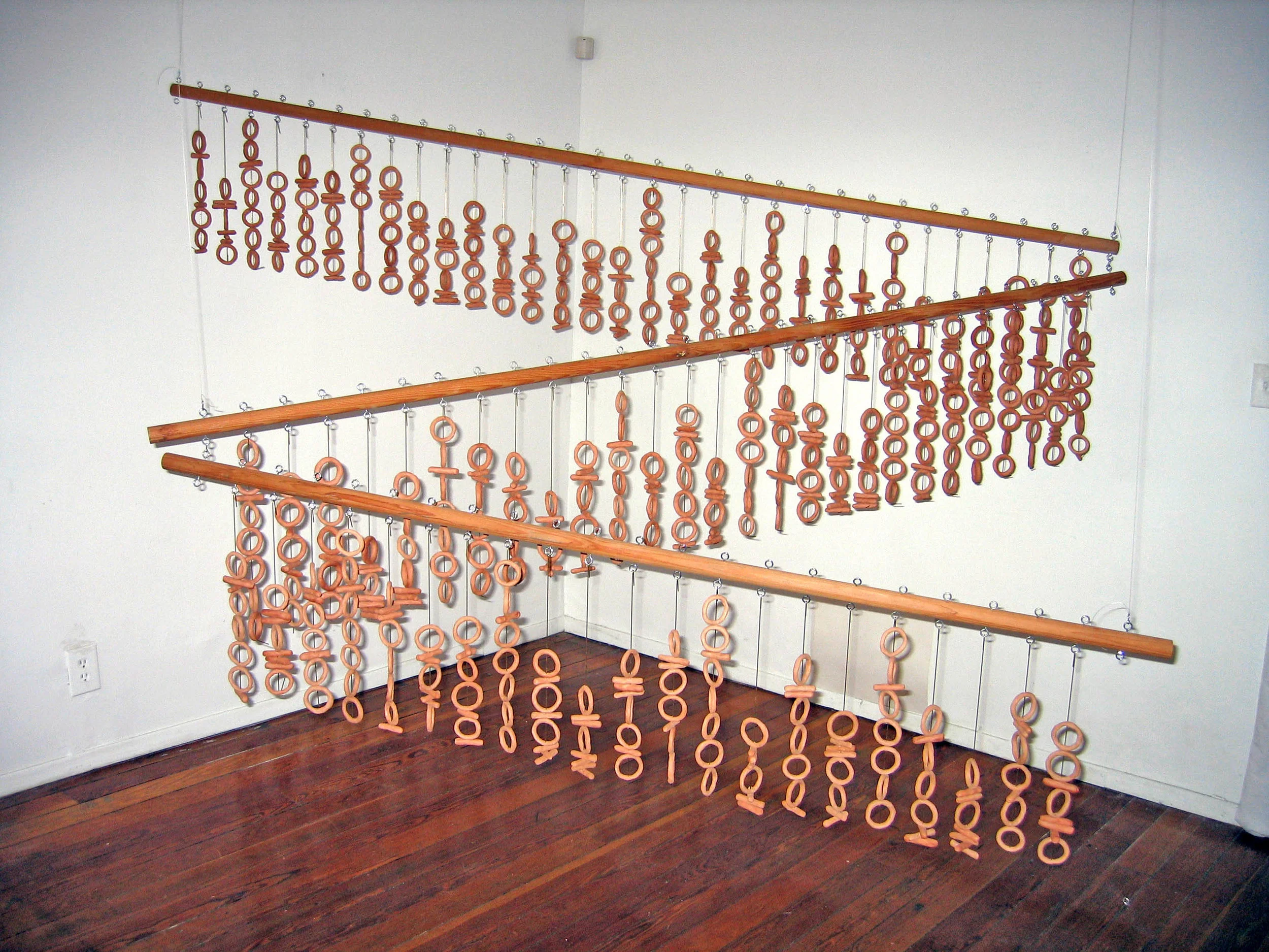 "In the beginning was the Word..." (Binary Triptych), 2001, Clay, metal and wood, 1 1/2 x 6 feet, 1 1/2 x 7 feet, 1 1/2 x 8 feet
