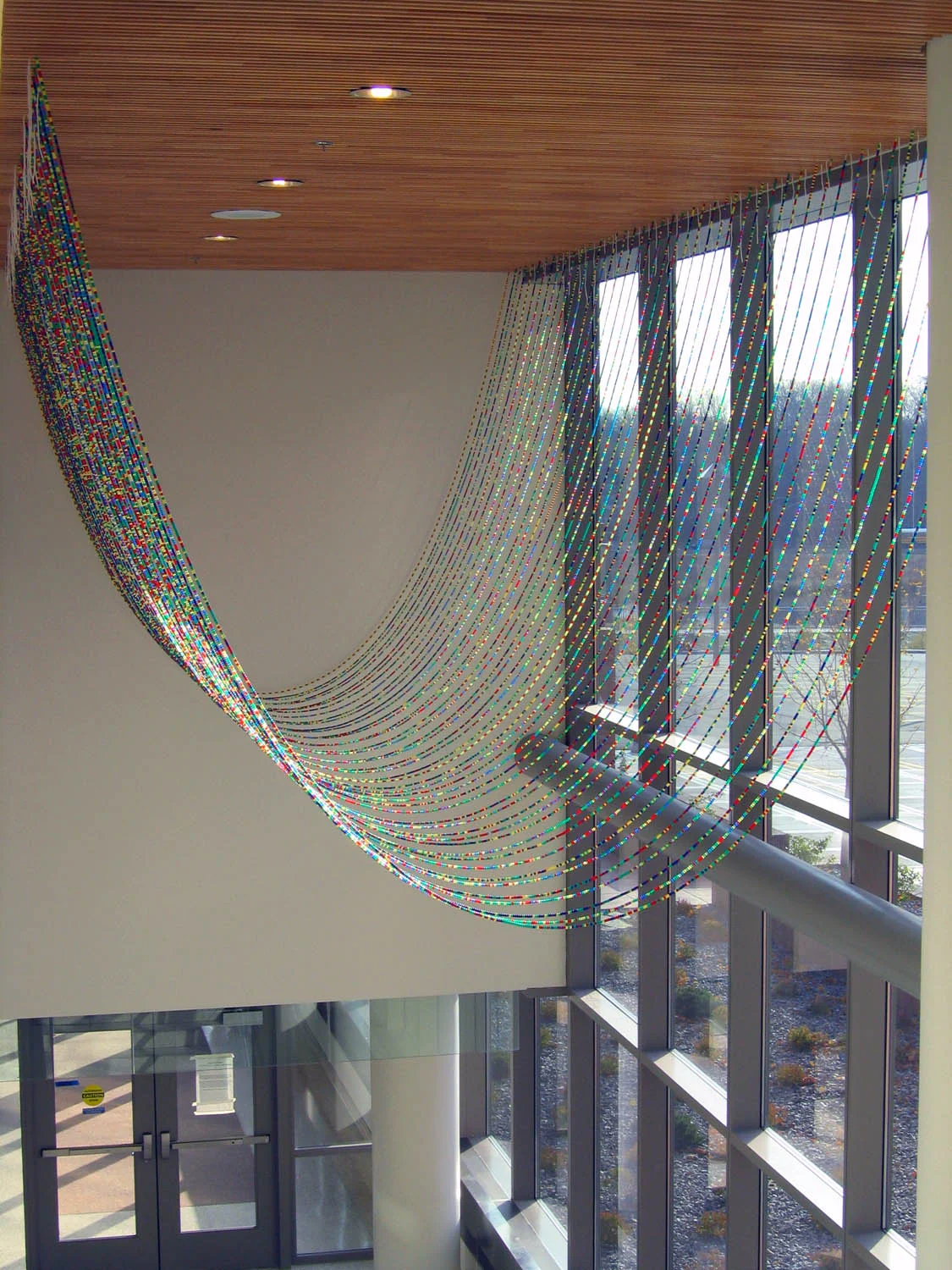 Gene Pairs ... With Ellipses, 2003, Plastic pony beads and nylon string, 35 x 25' (Installed at the Bureau of Criminal Investigation in Minneapolis, MN)