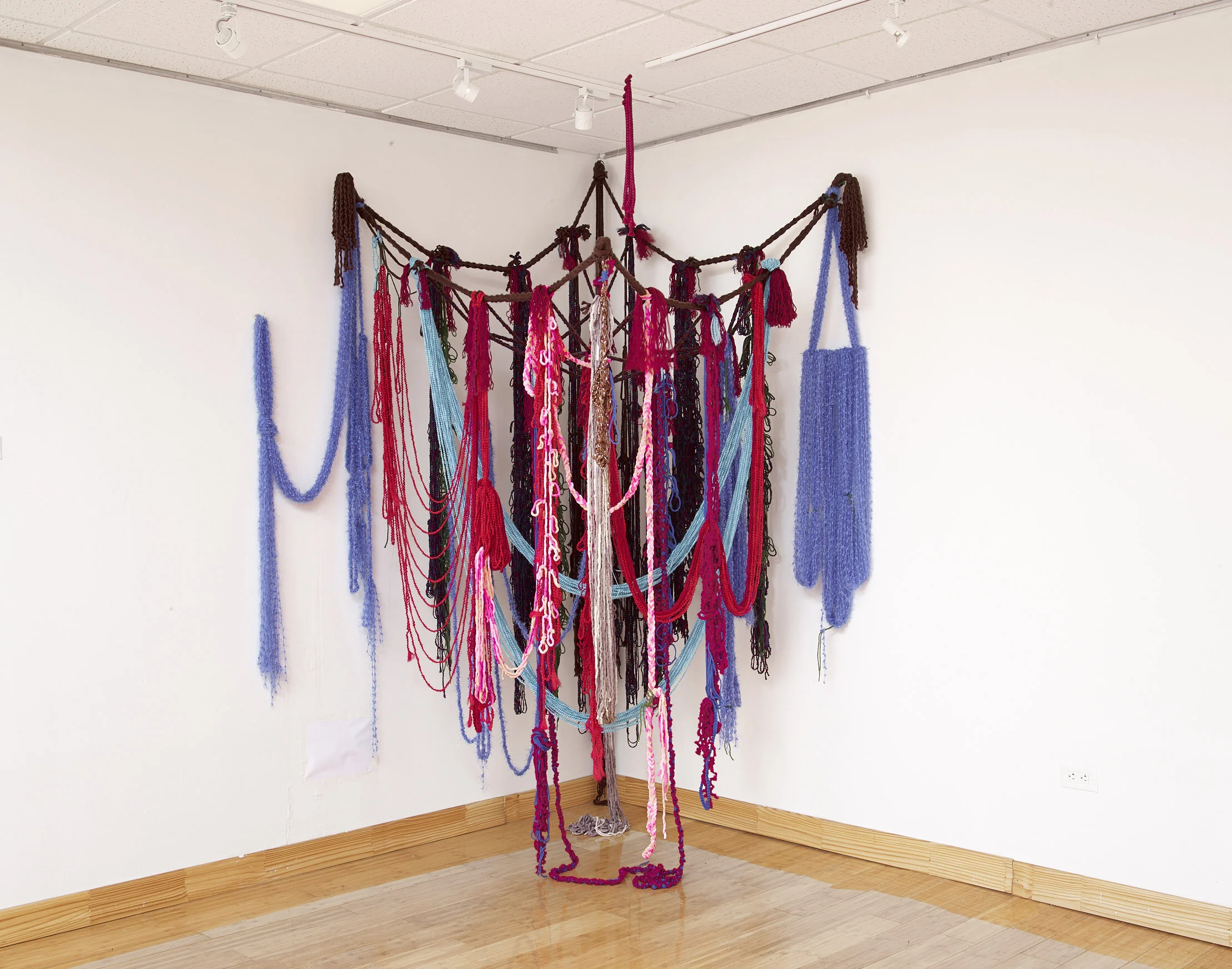 Infinity Scarf, 2019, Yarn, fishing line, cassette tape, and hardware, 50” x 50” x 100"