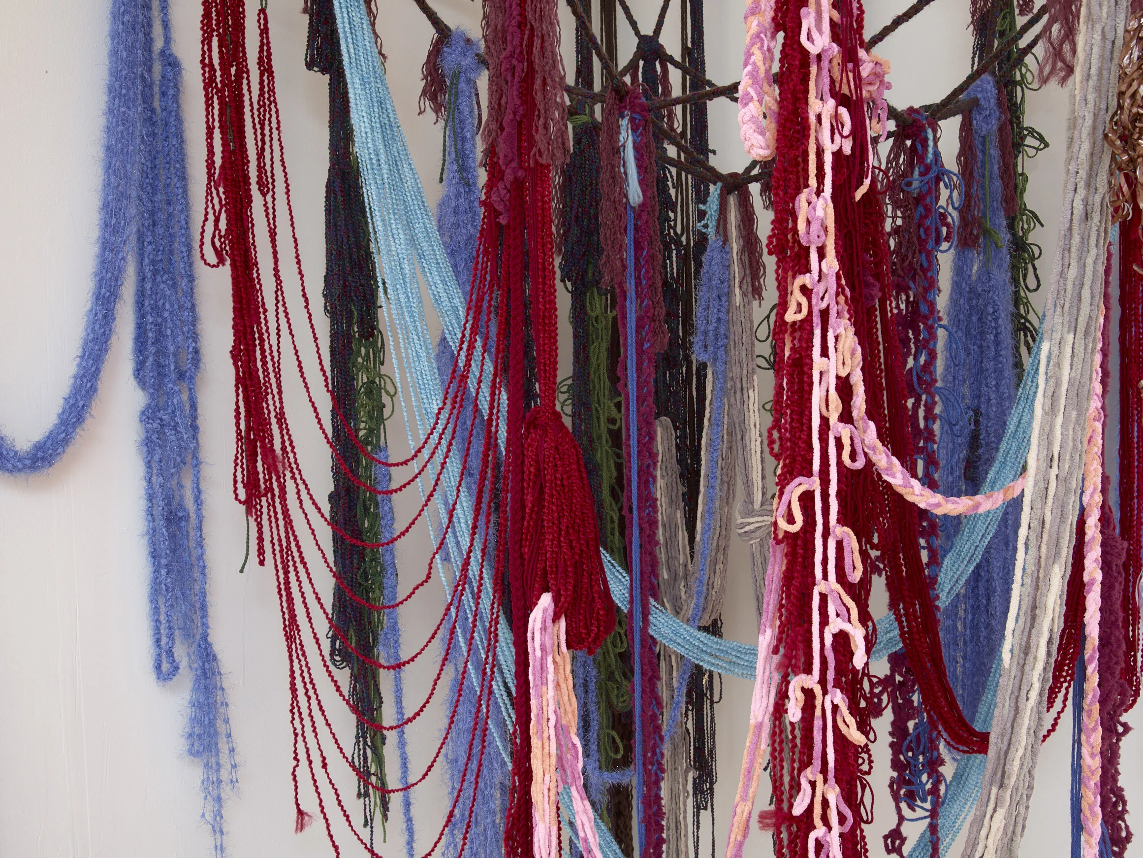 Infinity Scarf (detail), 2019, Yarn, fishing line, cassette tape, and hardware, 50” x 50” x 100"