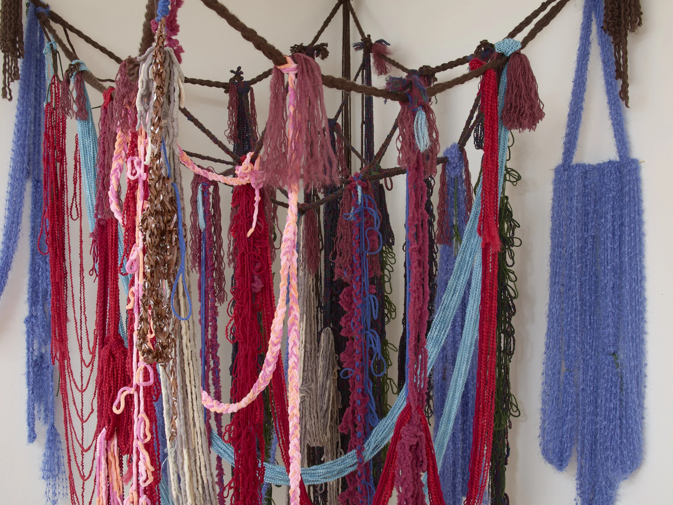 Infinity Scarf (detail), 2019, Yarn, fishing line, cassette tape, and hardware, 50” x 50” x 100"