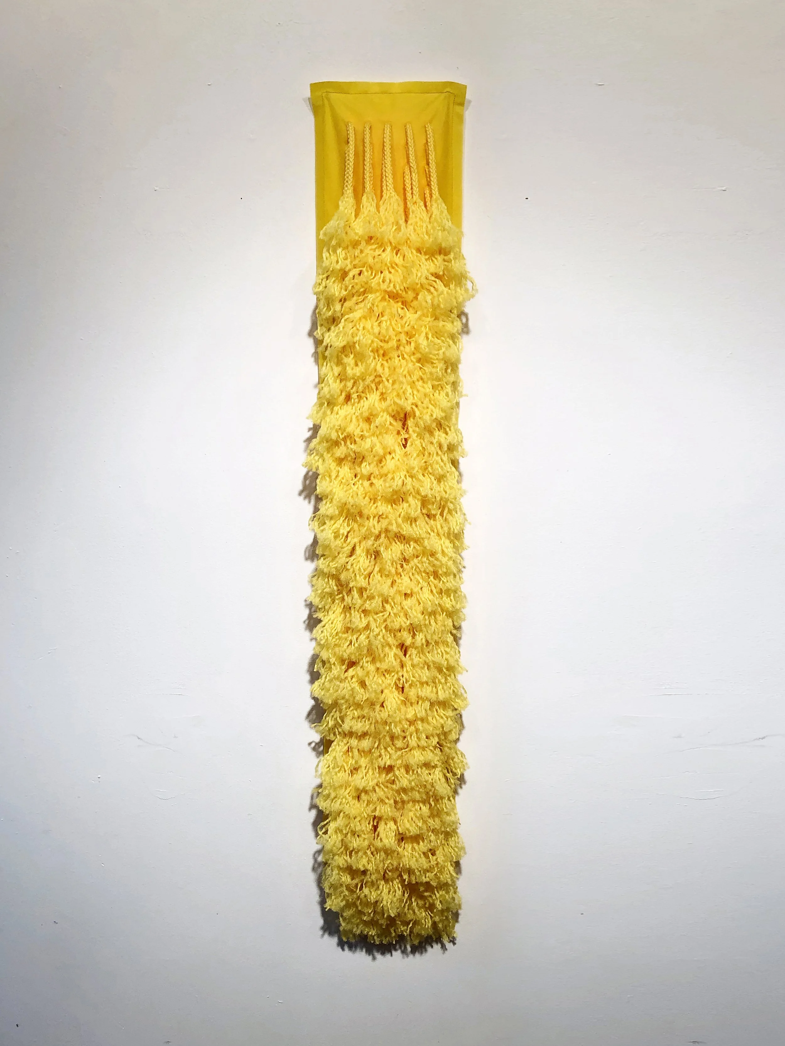 Ellie Murphy, Yellow Fleece, 2022, Macrame and non-woven fiber, 8" x 48" x 4"