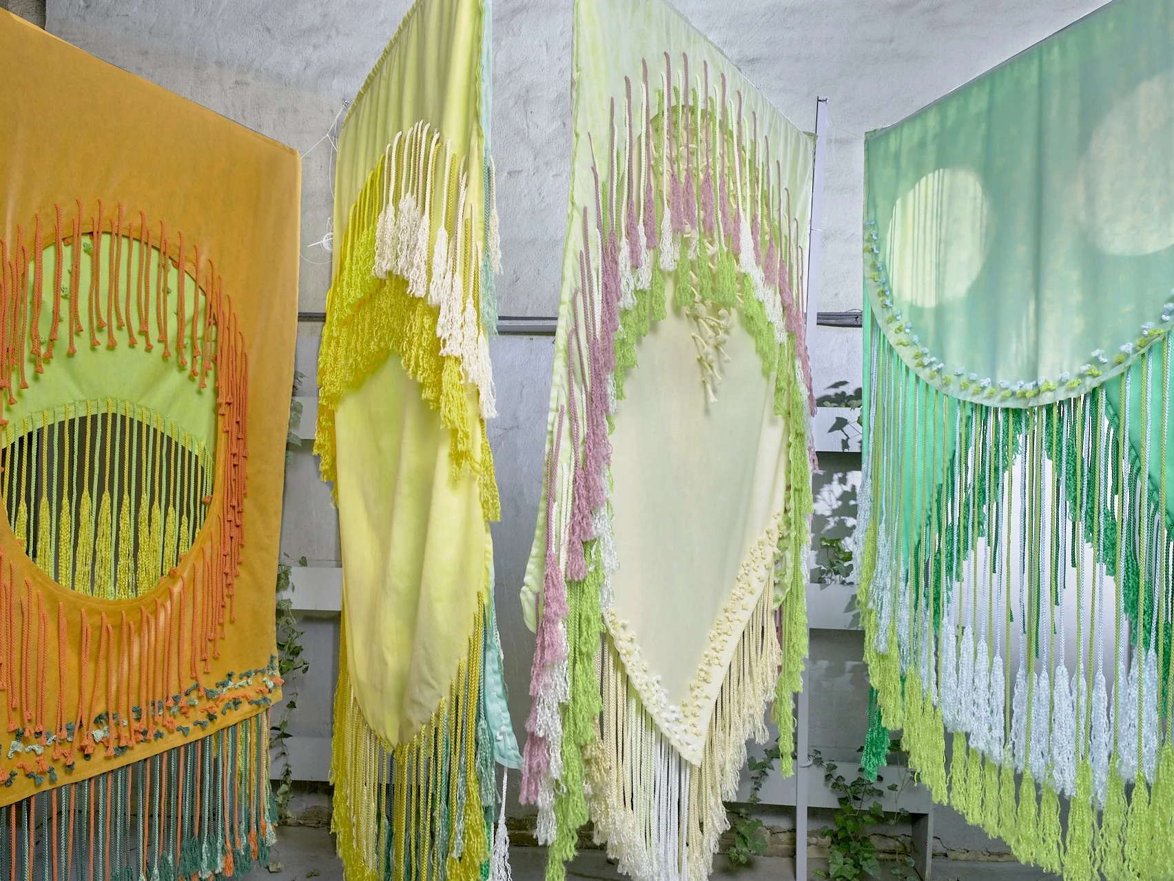 The Monocots, 2024, Non-woven and macramé fiber, Installation in four parts, each approximately 48” x 84” (2 sided); Left to right: Wheat/Milo, Corn/Onion, Pampas/Orchid, Iris/Palm 