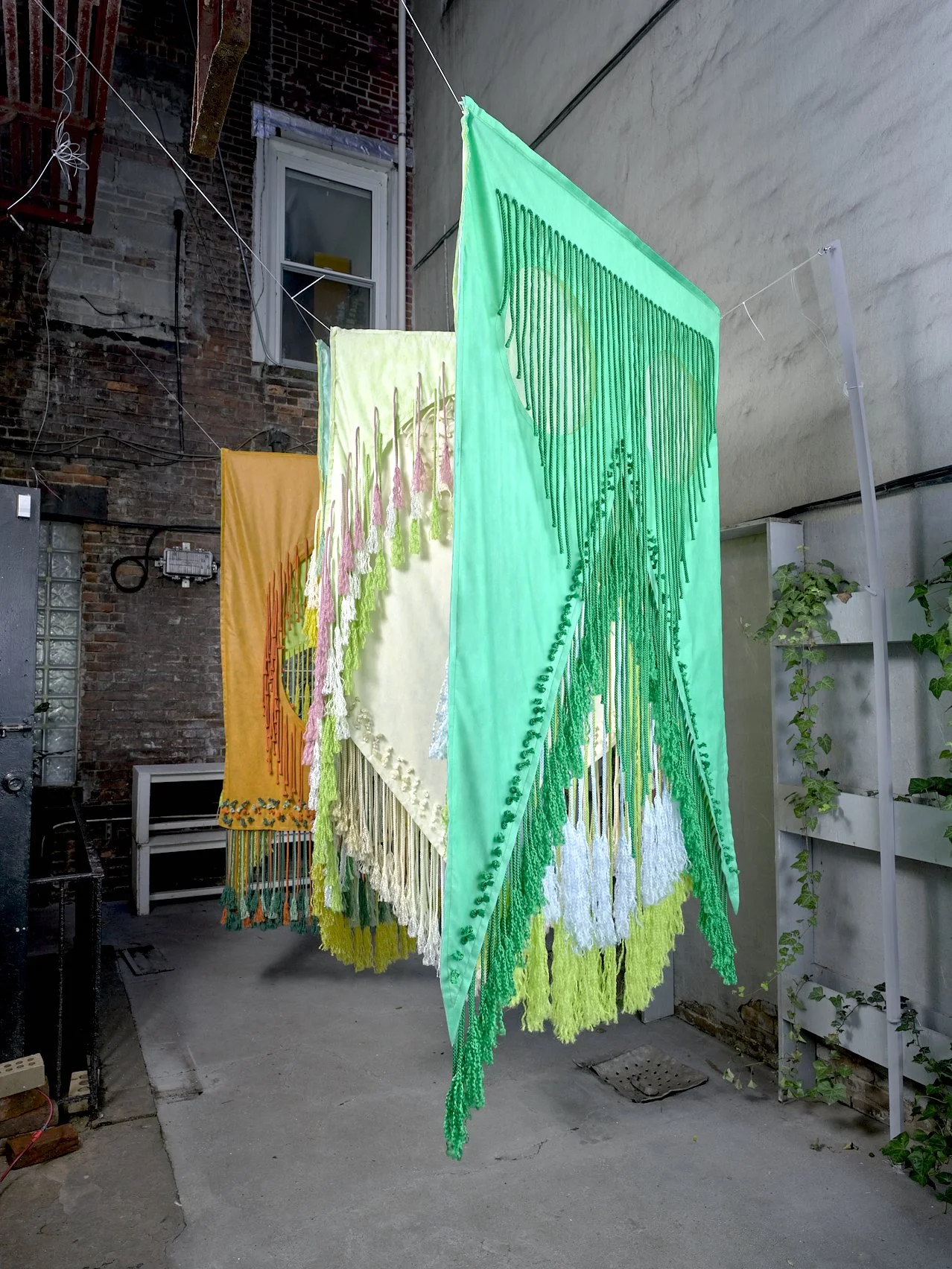 The Monocots (detail), 2024, Non-woven and macramé fiber, Installation in four parts, each approximately 48” x 84” (2 sided); Left to right: Wheat/Milo, Corn/Onion, Pampas/Orchid, Iris/Palm 