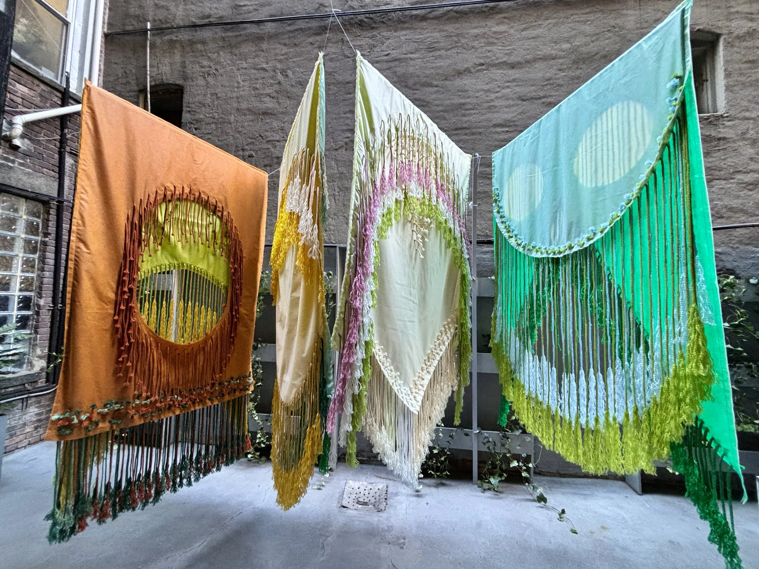 The Monocots, 2024, Non-woven and macramé fiber, Installation in four parts, each approximately 48” x 84” (2 sided); Left to right: Wheat/Milo, Corn/Onion, Pampas/Orchid, Iris/Palm 