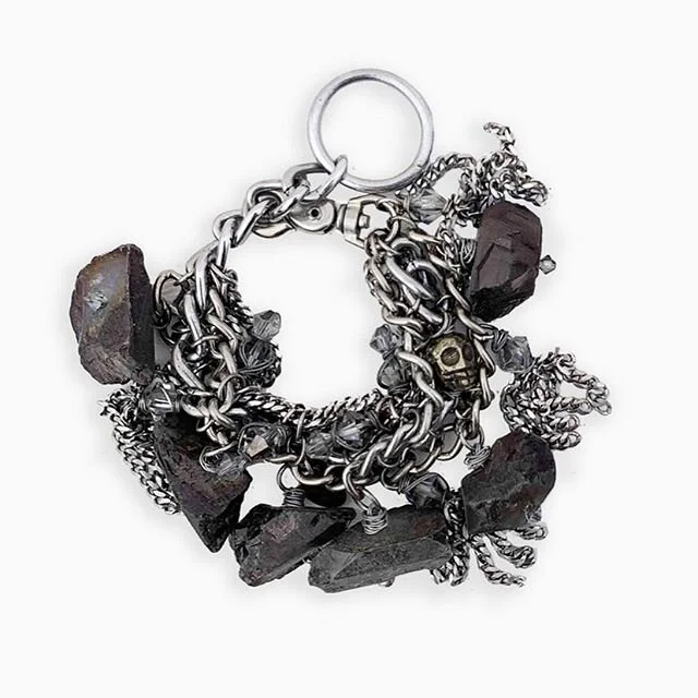 This Hermes charm bracelet (named after the Greek god of trade and traveling 🧳💀⛓) can be transformed from a necklace to a bracelet with the extender piece. It&rsquo;s made with sterling silver and stainless steel hardware with glass smoky beads, py