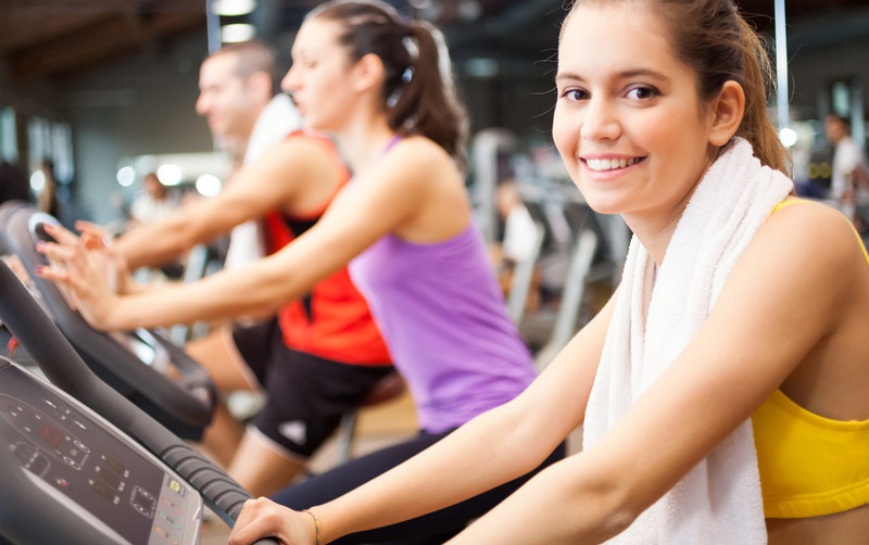 people-working-out-in-gym-with-cardio-equipment.jpg