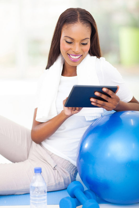 african-woman-with-exercise-ball-and-tablet.jpg