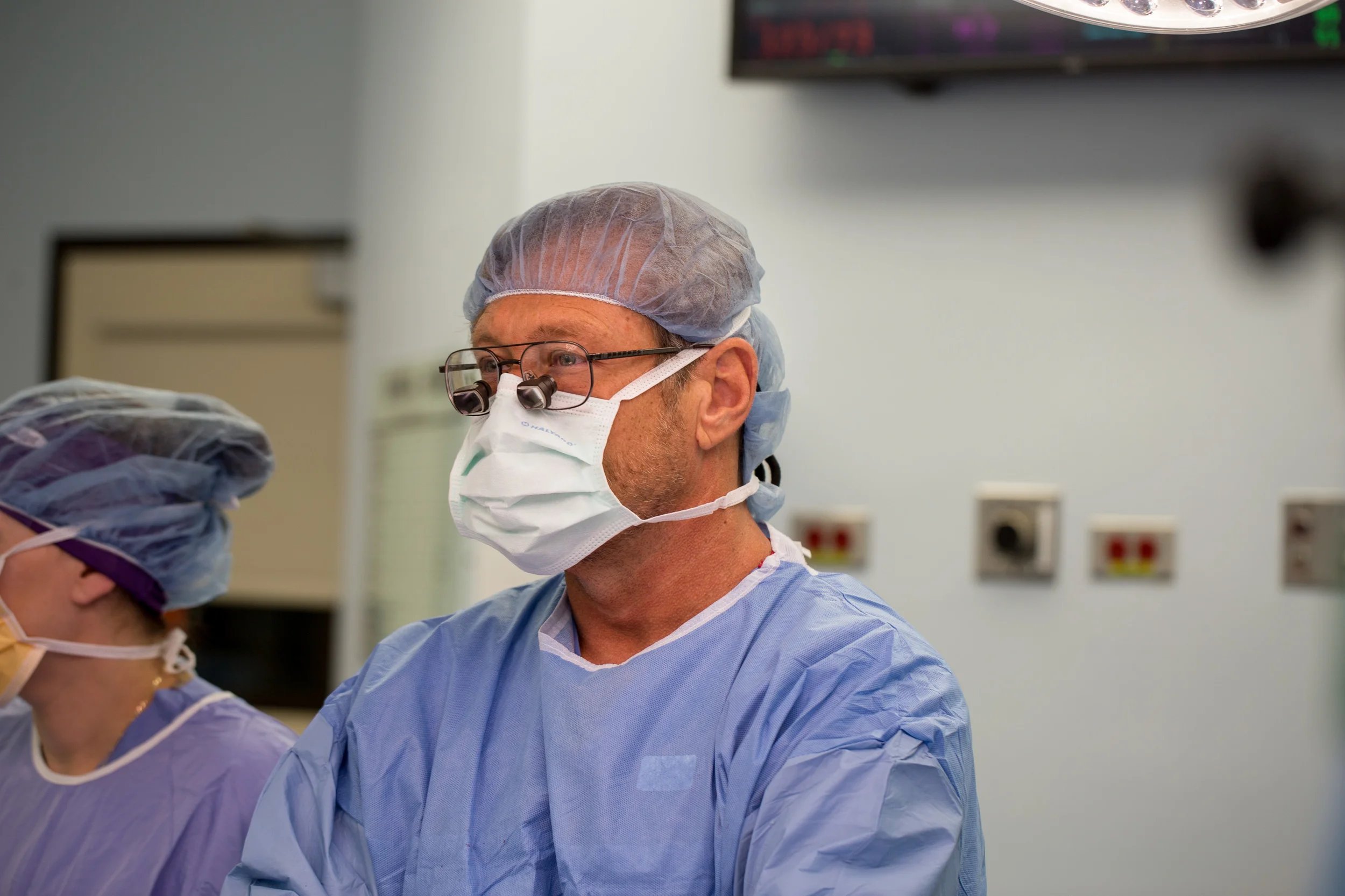  A surgeon looks on during a femoral artery bypass procedure.&nbsp; 