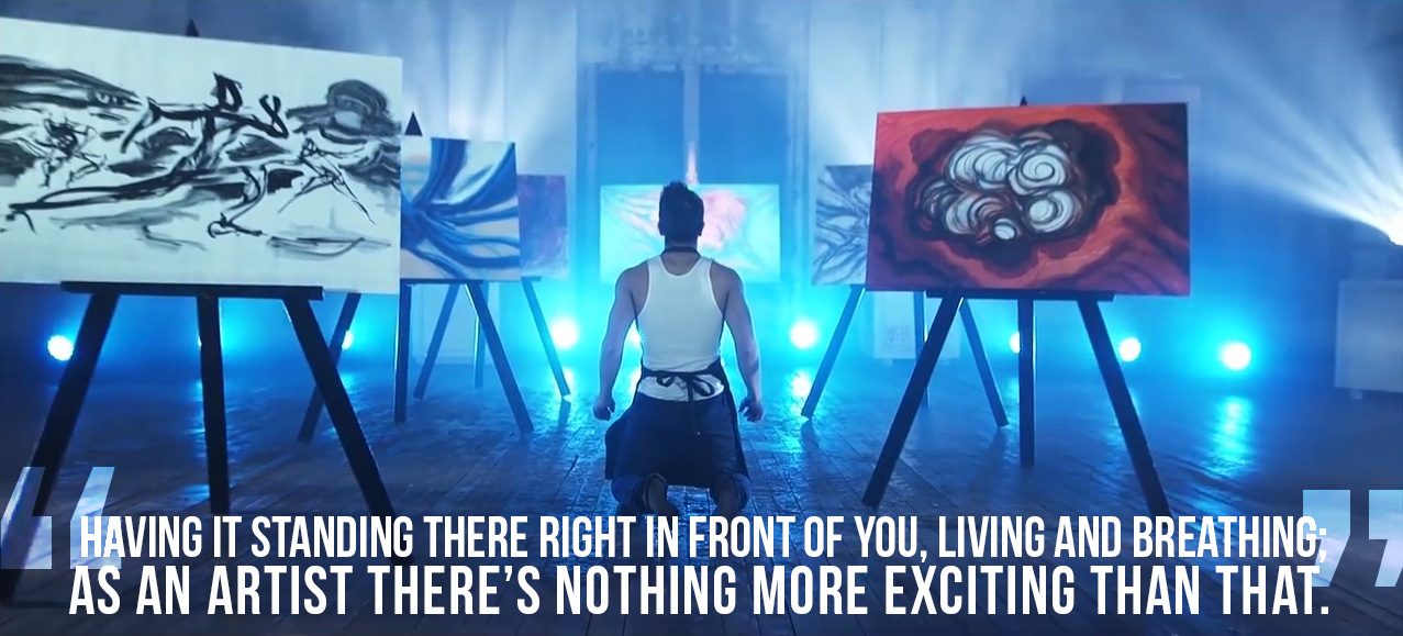 Tannos in a scene from The Process, with Artist Hendrik Gericke's paintings.