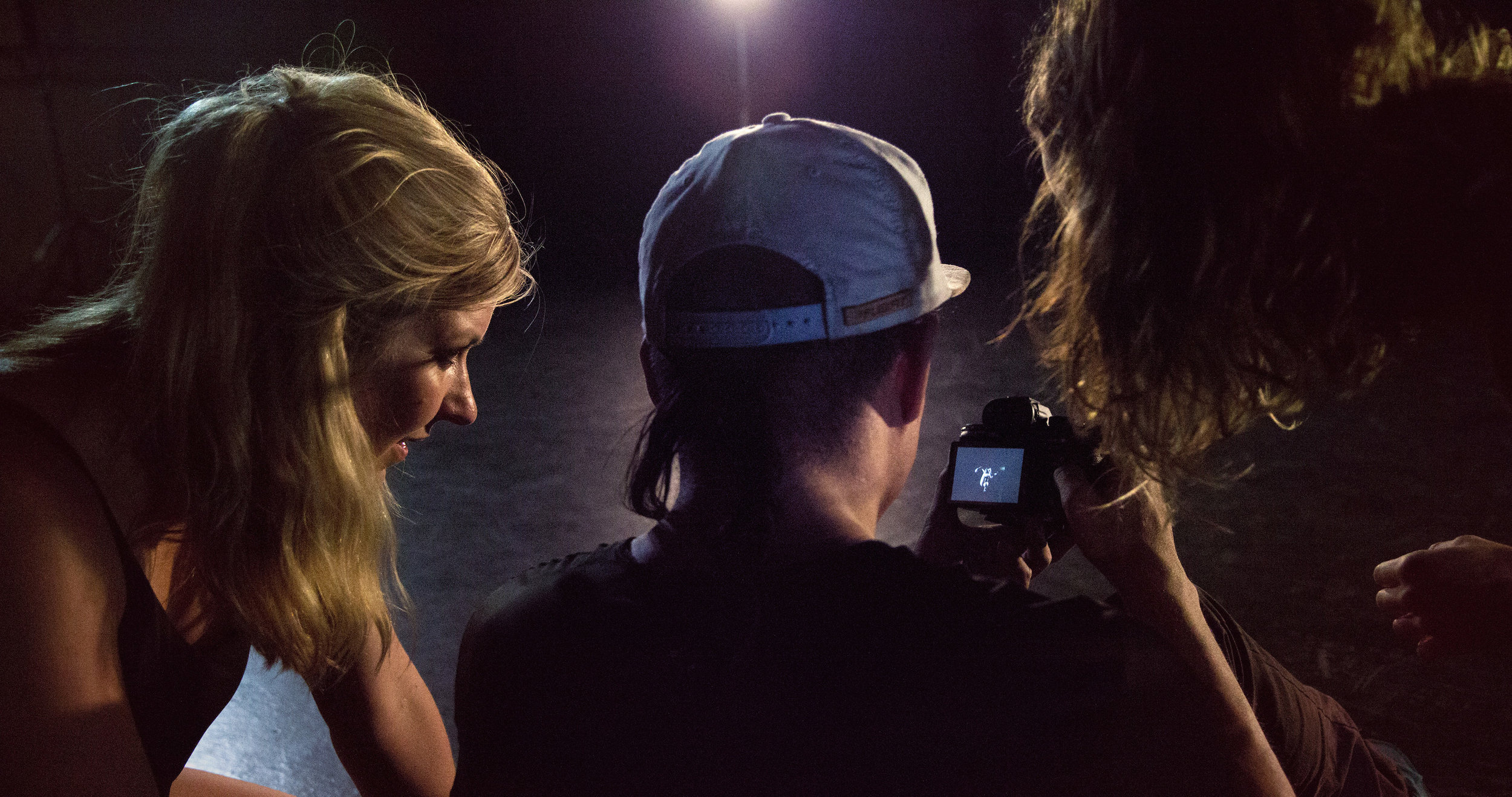 Sarah (left) with videographer Frace Luke Mercado and Dream Dance Company member watches back footage during filming for Enter the Vortex's promotional release.