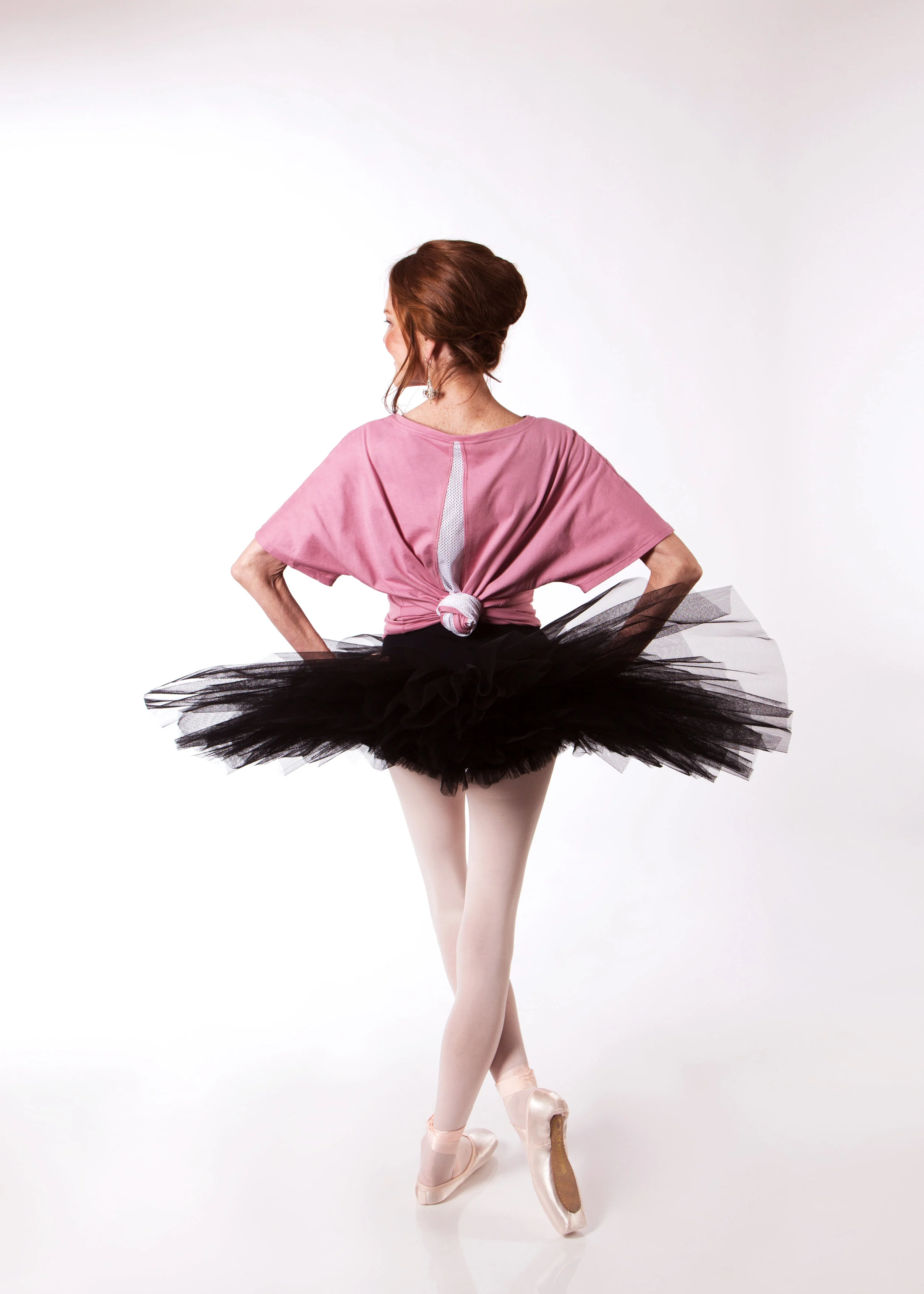 Carol wears a Half Tutu in Black, with the Grace Detailed Back Tee in Dusty rose and Energetiks Sapphire Pointe Shoes