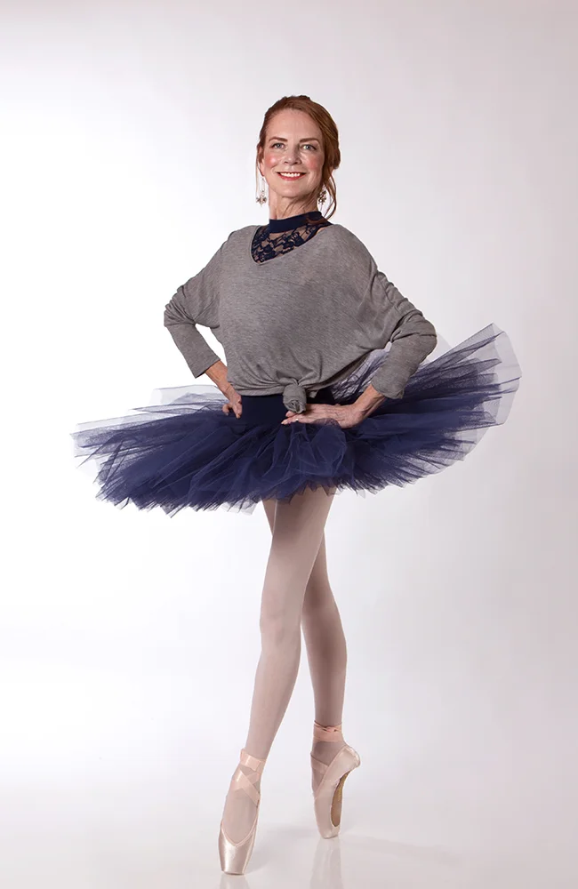 Carol wears the Scarlett Leotard and Half Tutu in Navy, with the Studio Pullover in Grey Marle and Energetiks Sapphire Pointe Shoes