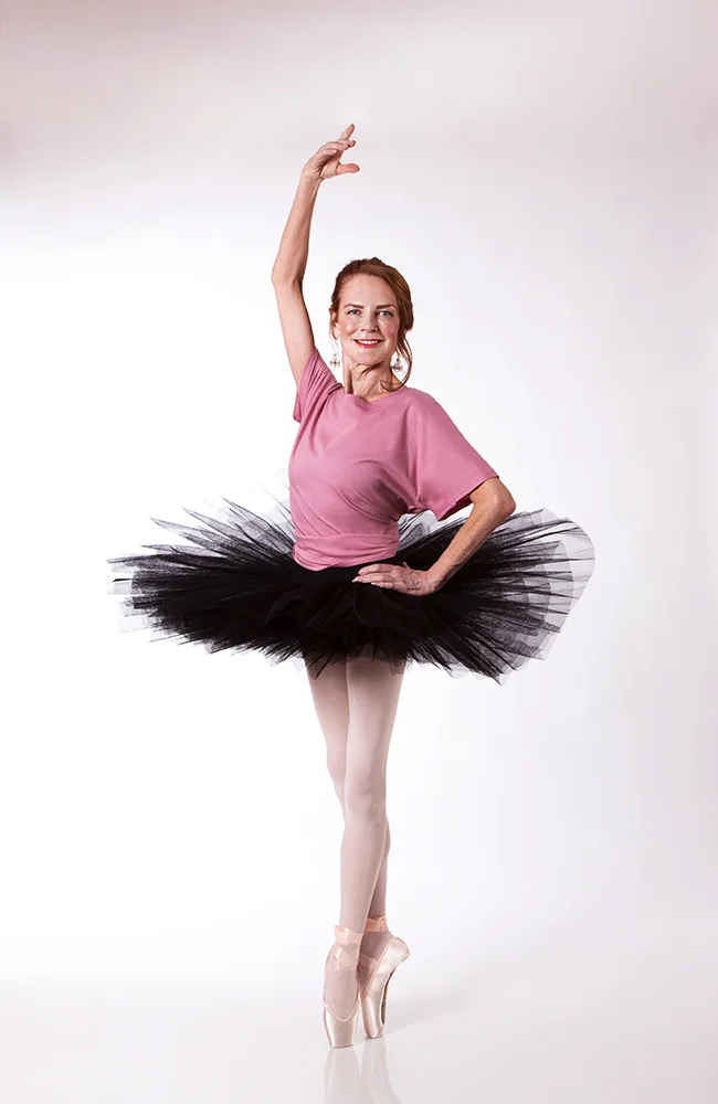 Carol wears a Half Tutu in Black, with the Grace Detailed Back Tee in Dusty Rose