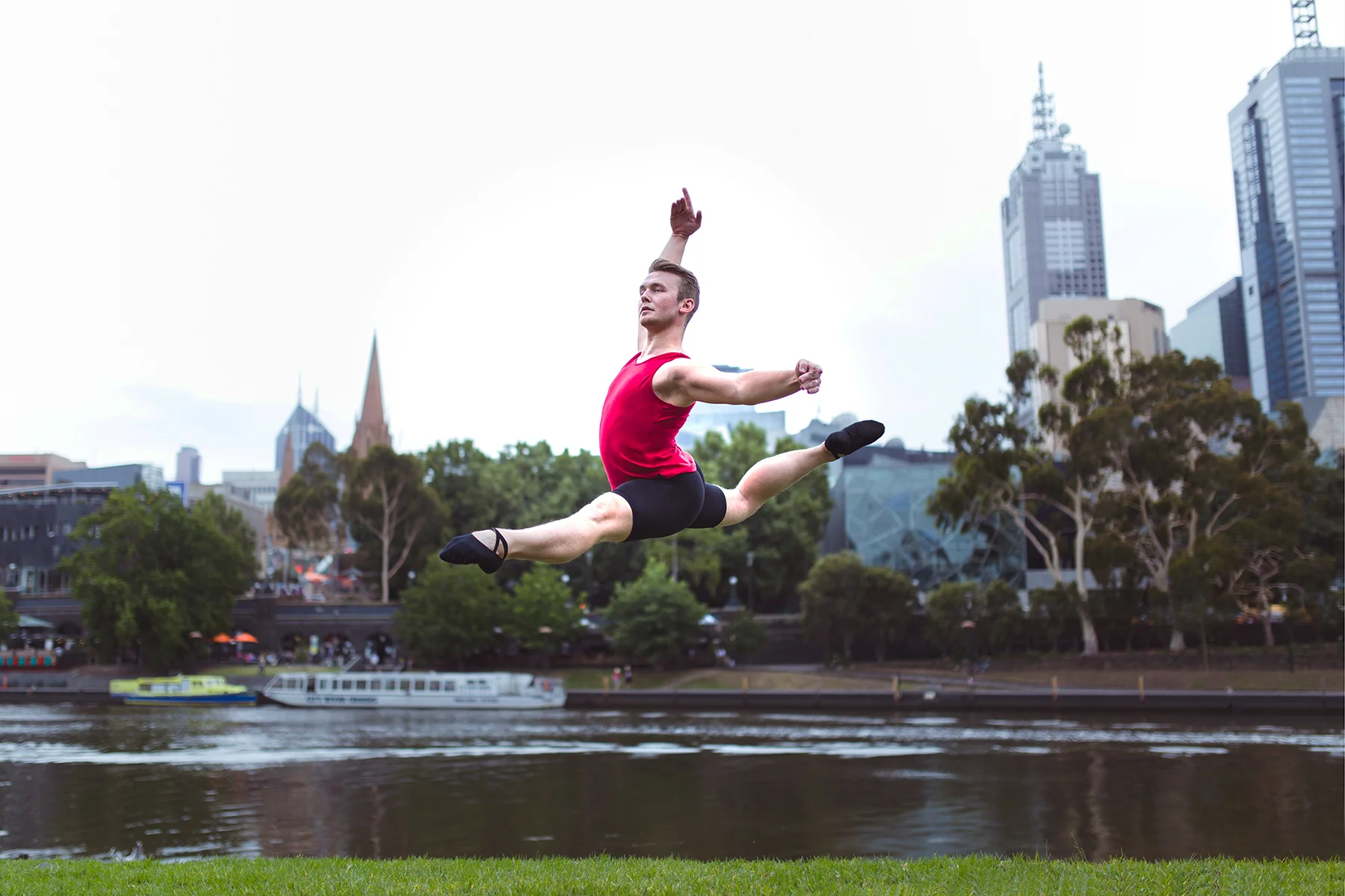 Jake wears the Men's Tank in Red with Bike Shorts in Black