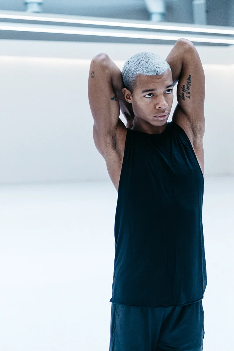 Louis wears the Urban Short and Low Back Singlet in Black