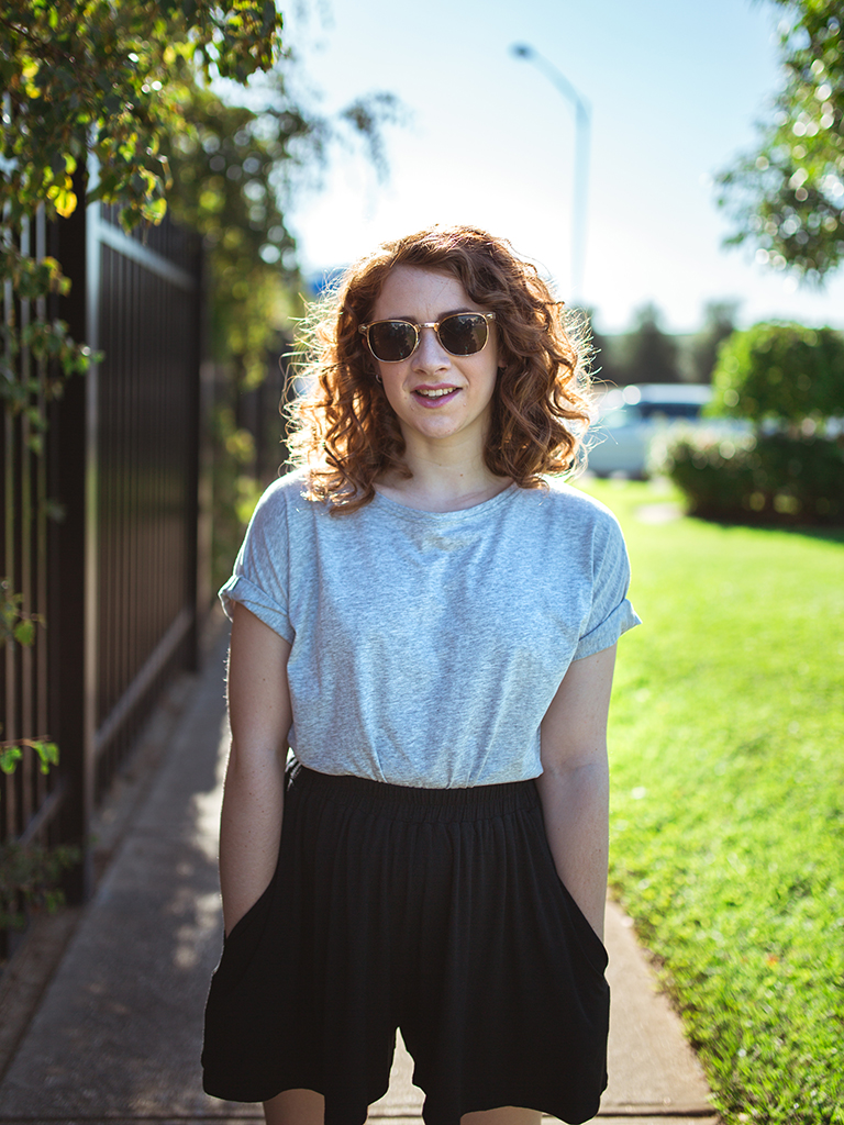 Devon wears the Grace Detailed Back Tee in Grey Marle and the Sadie Volume Short in Black from the Atelier Collection