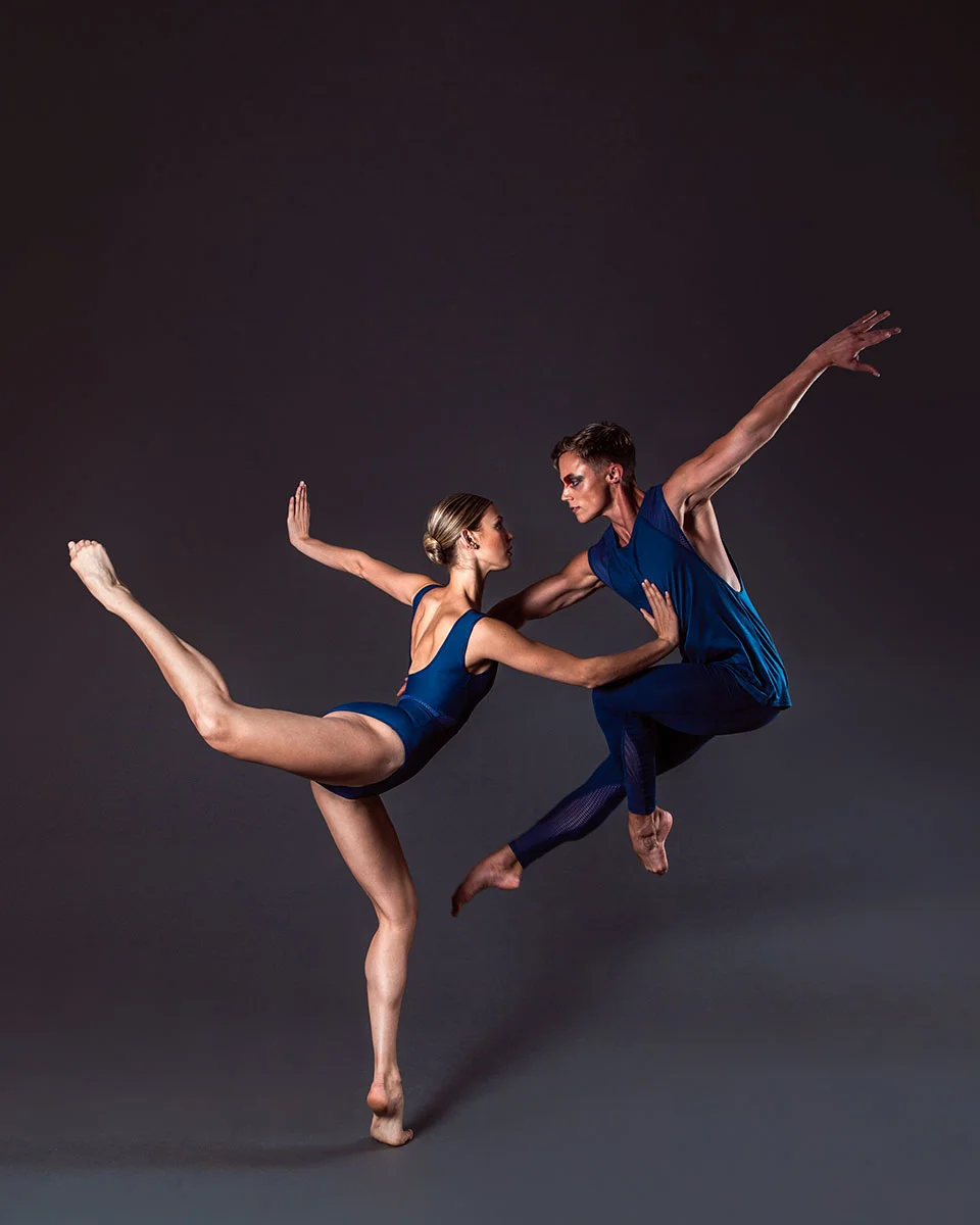 Zoe wears the Misha Leotard and Jack wears the Alpha Legging and Aero Singlet in Midnight Blue.