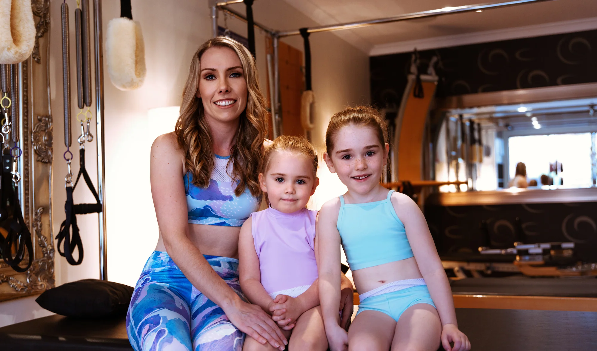 Kate Boyle with daughters Charlotte and Ava in the Energetiks Moonstone Collection . Kate wears the Jasmine Crop and Lanna 7/8th Legging in Moonstone, Charlotte wears the Willow Crop and Emily Short in Lavender, and Ava wears the Coco Crop and Emily Short in Spearmint.