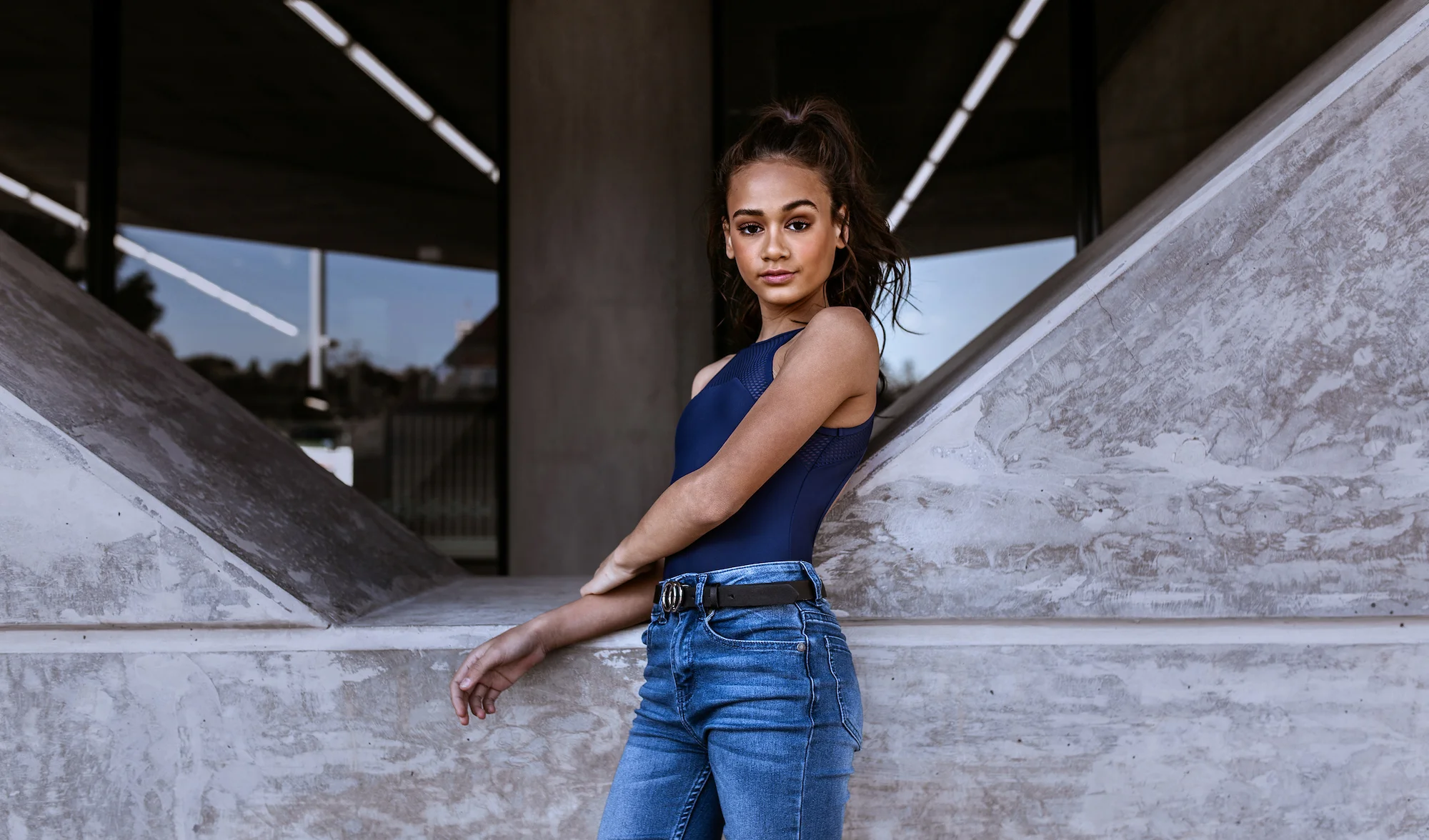 Mackenzie wears the Adele Camisole in Deep Ink, paired with the Ingrid Pullover in Grey Marle