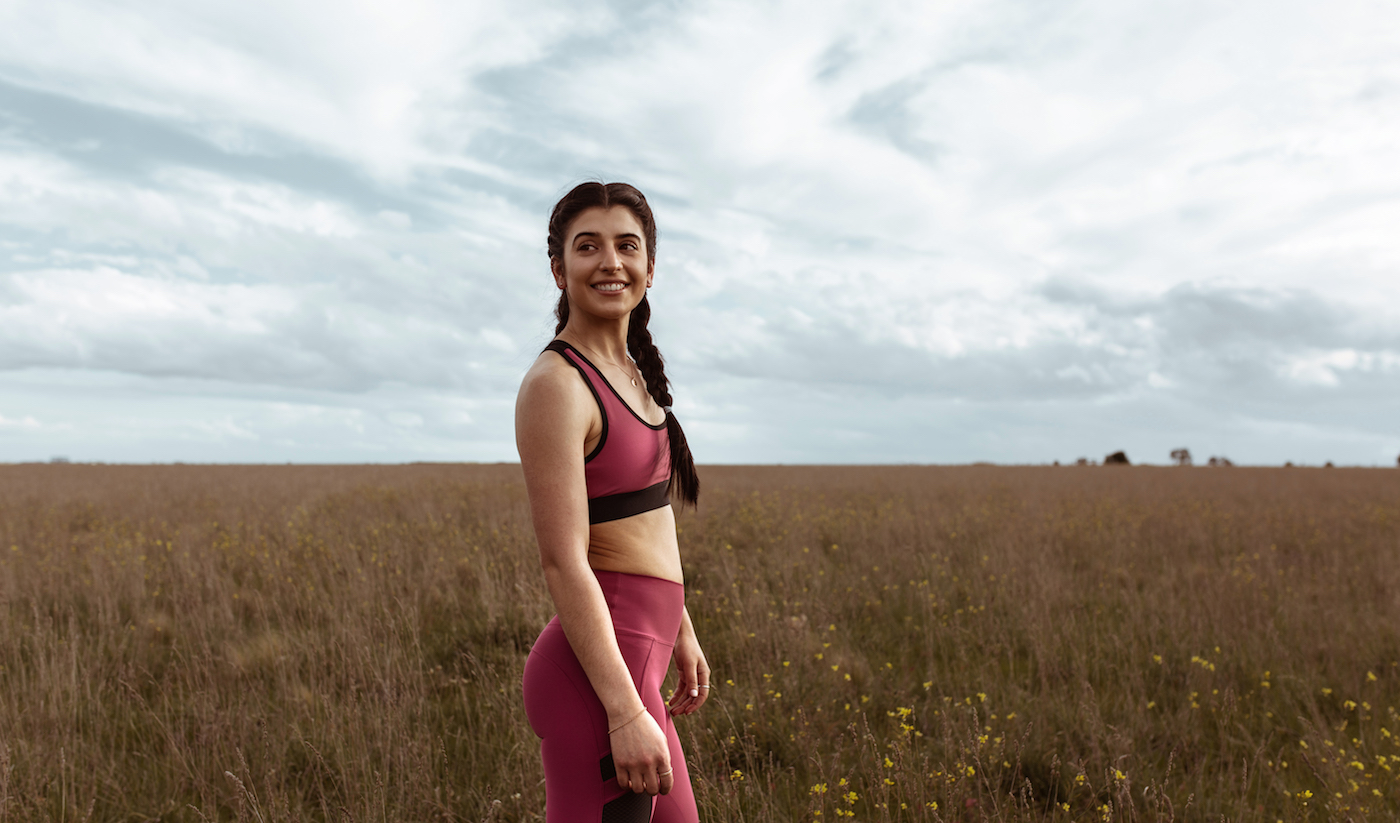 Grace wears the Gemini Eve Crop Top and Camilla Legging in Dewberry.