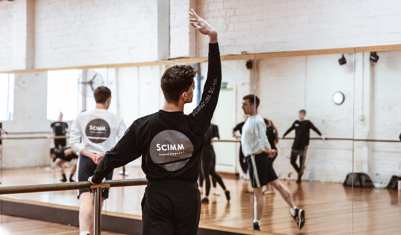  Scott Pokorny (Foreground) and Tim Barnes taking company class with SCIMM Dance Company’s professional dancers  