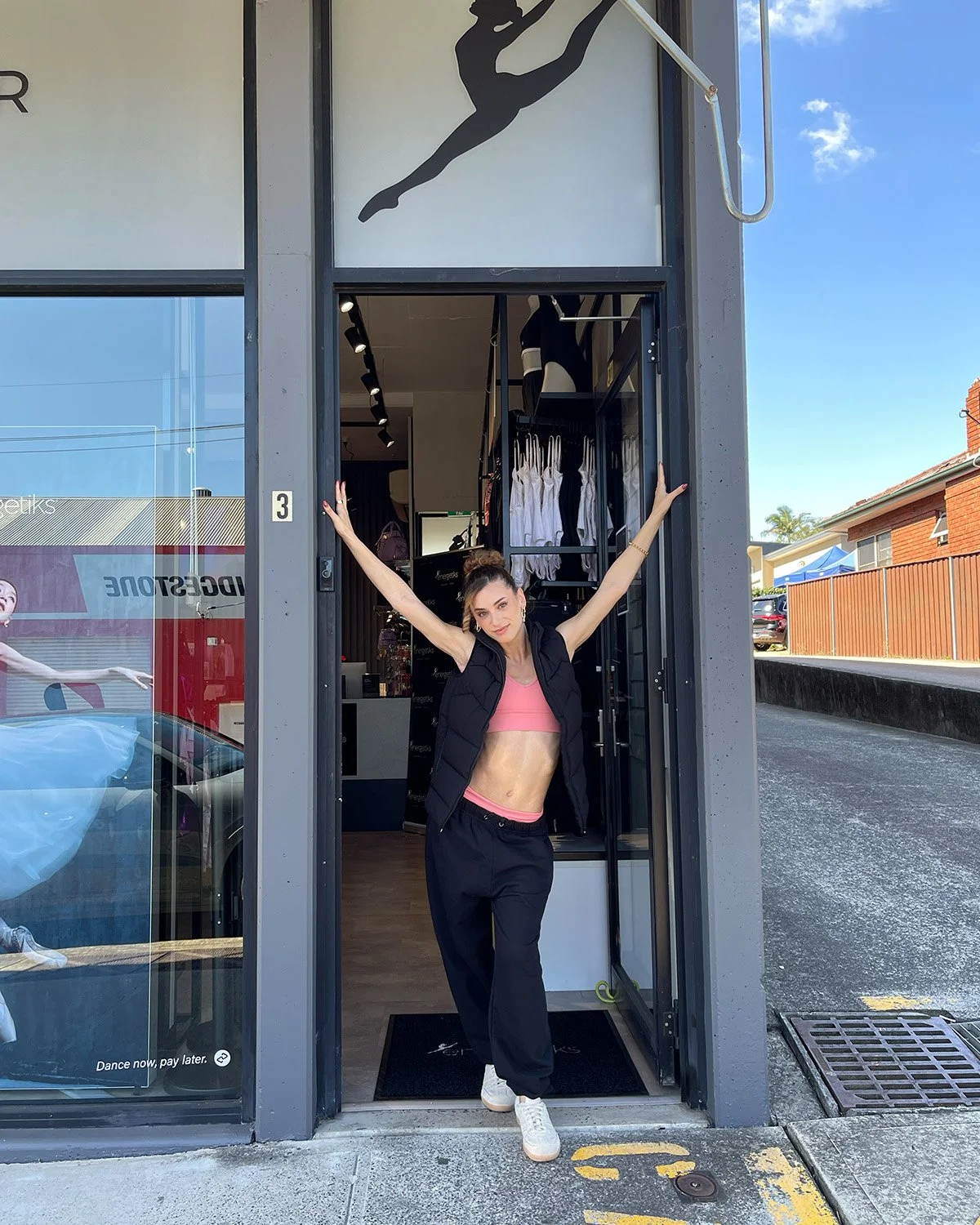 Felicia wears the Jax Puffer Vest, Natalie 4-Way Crop Top, 3'' To 4'' Short, Avery Classic Track Pant