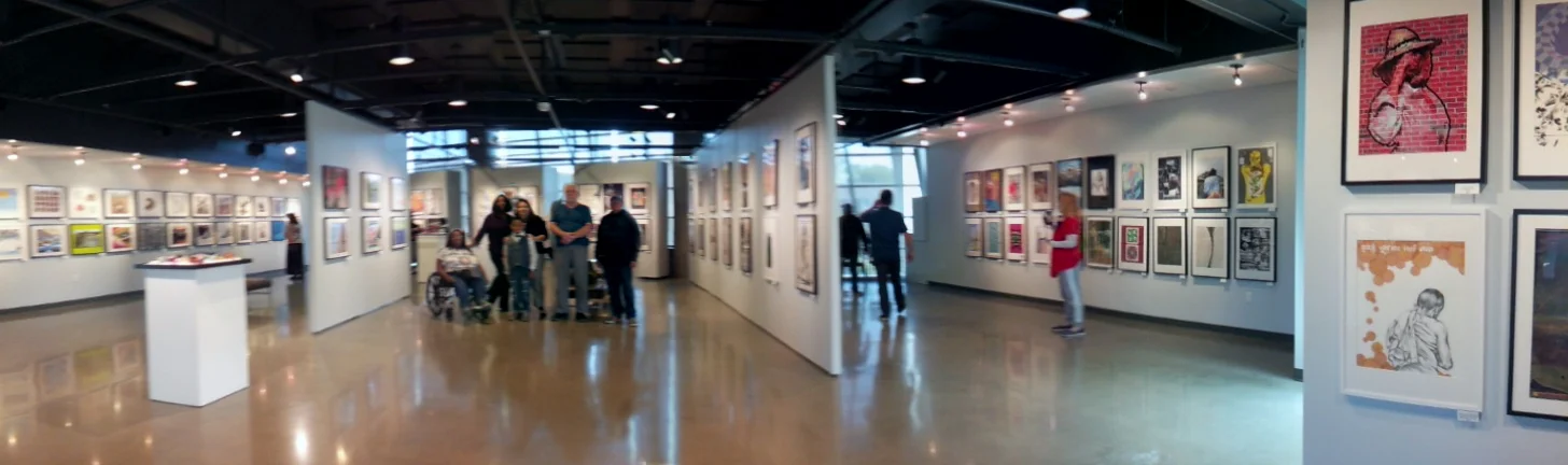 The Heninger Villagers stand together among their works on display at the beachfront Coastline gallery in Newport Beach, CA
