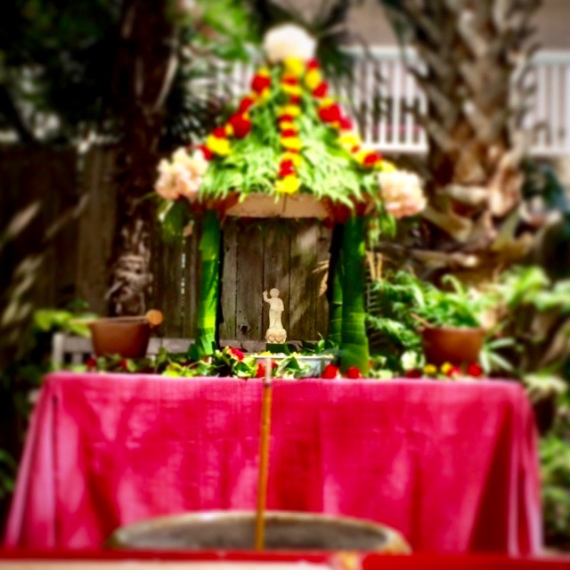 While chanting, water is poured onto the baby Buddha. Photo by Daniel Zamora