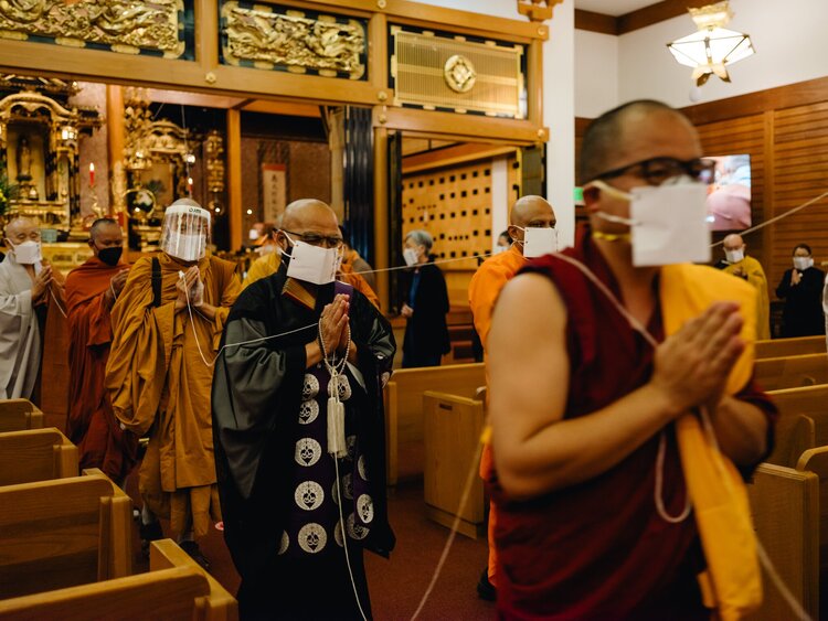 Leaving the ceremony, connected by the long thread originating from the Buddha.