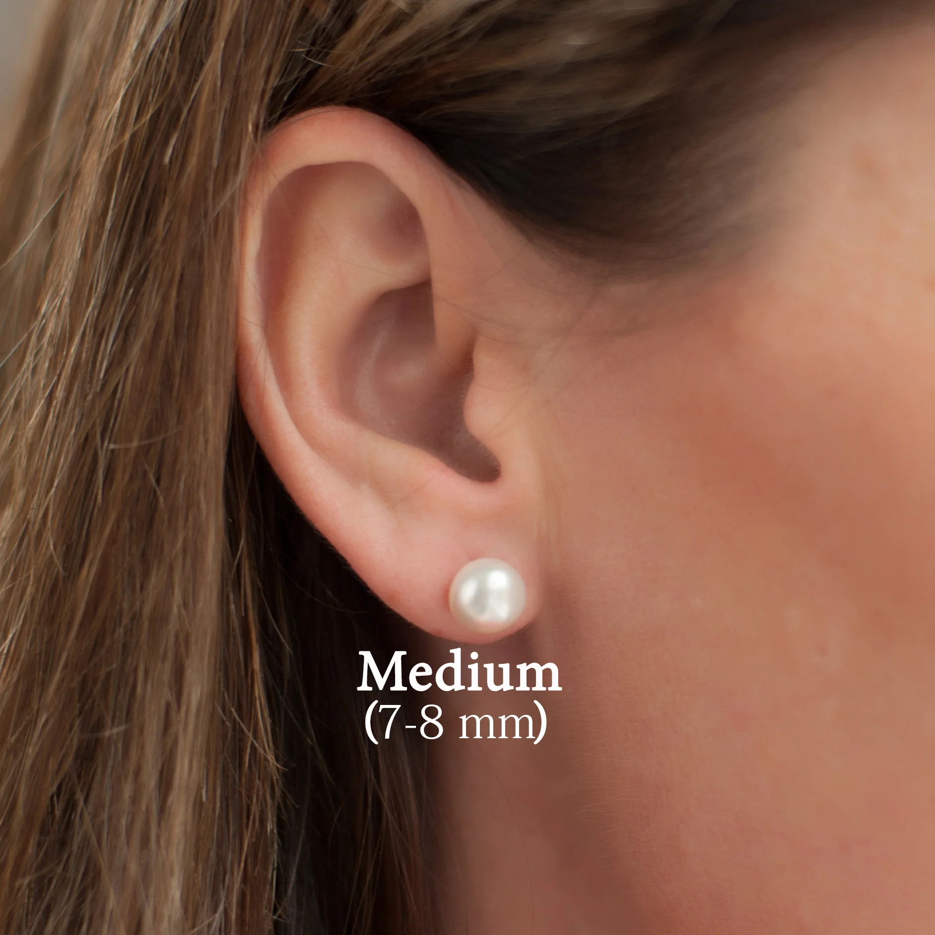 Medium-pearl-stud-earrings-on-model.jpg