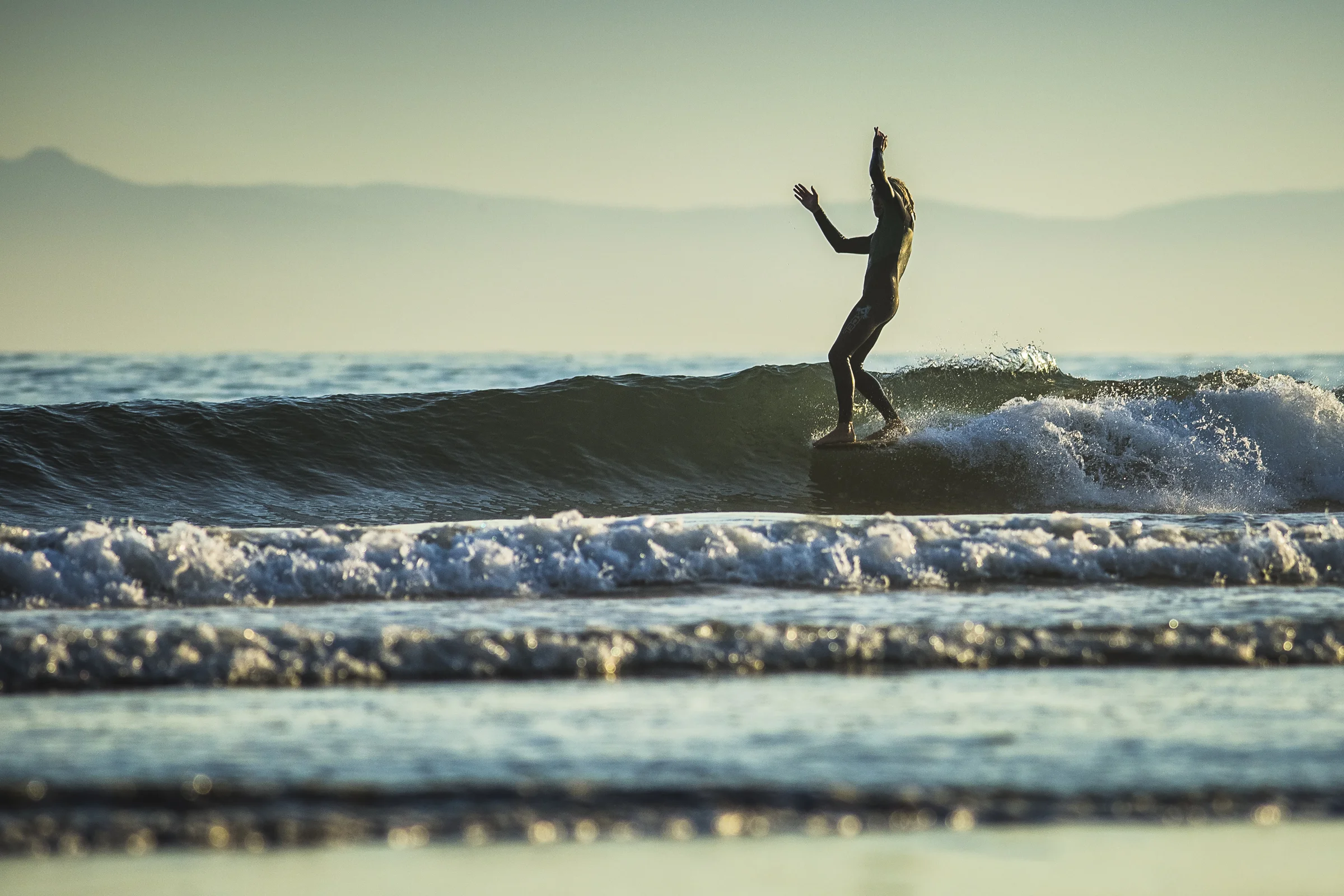  Handheld, Longboarder gets five toes on the nose at Rincon Point, California 