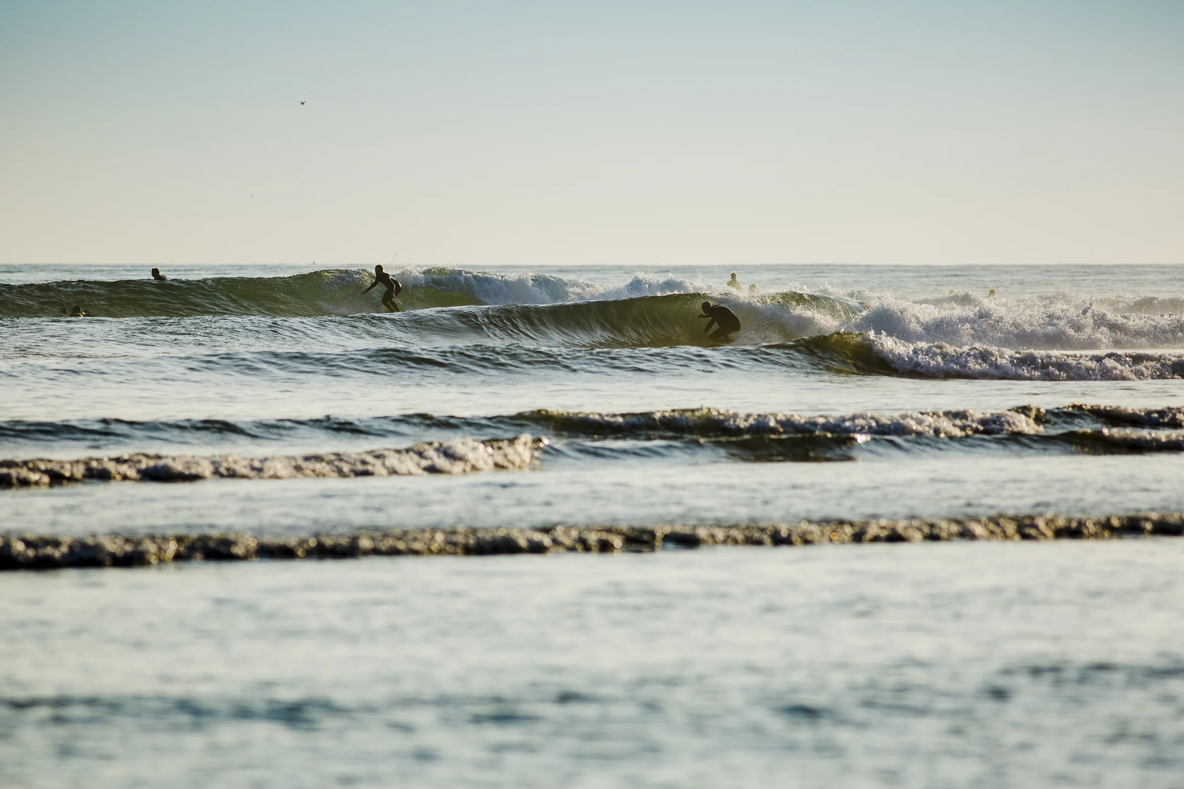  2 Surfers share a set of waves at Rincon Point, Ca. Handheld AI servo 